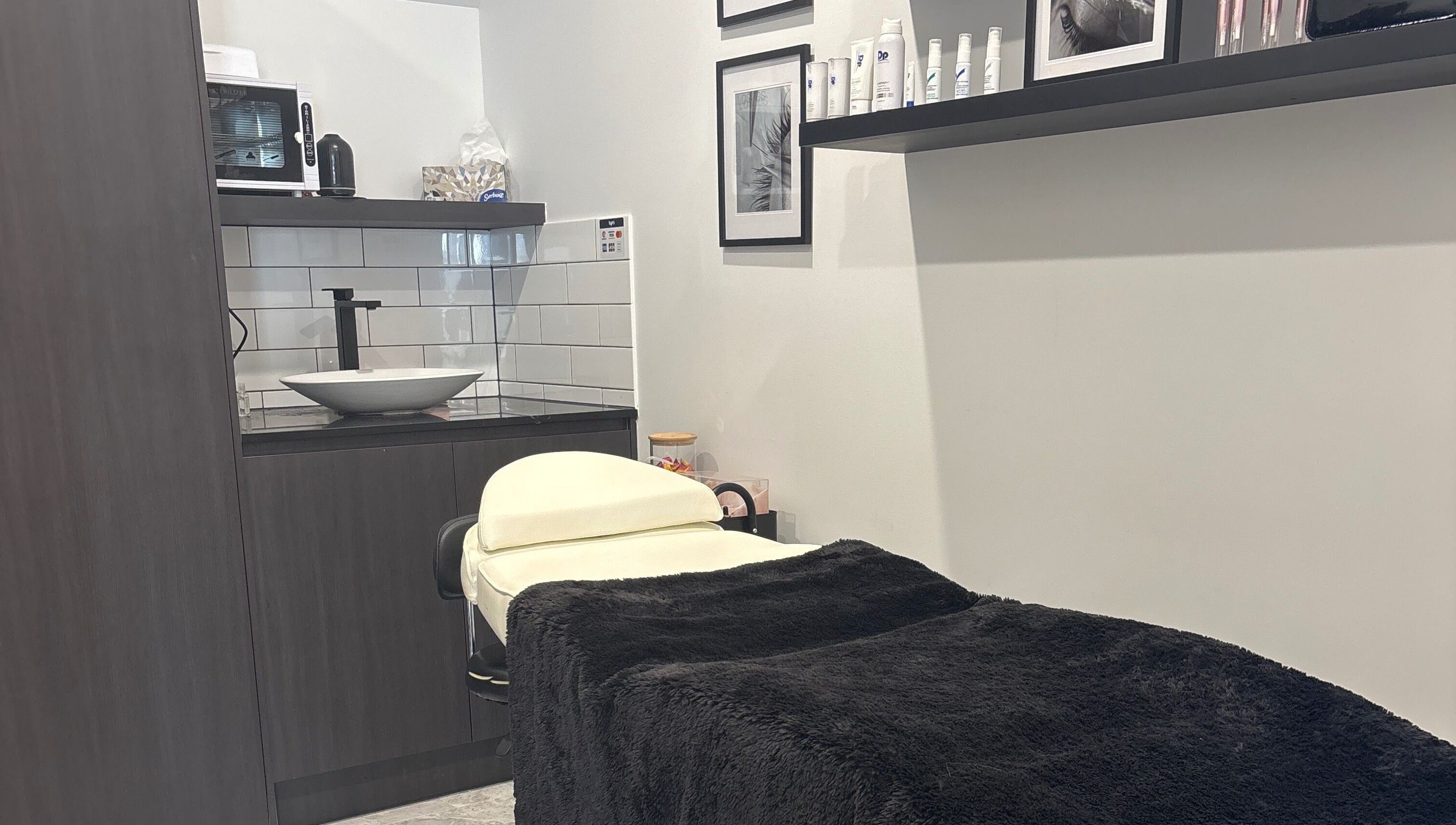 Cozy treatment room at Illusive Beauty, Nirimba, Queensland, AU with a massage table and stylish decor.
