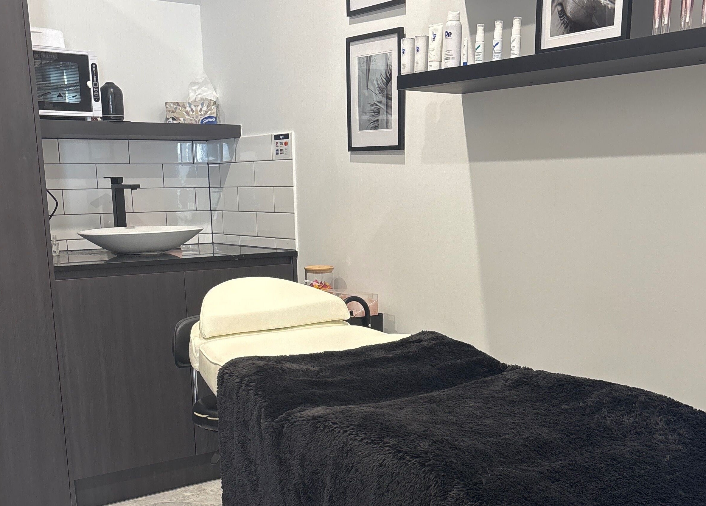 Cozy treatment room at Illusive Beauty, Nirimba, Queensland, AU with a massage table and stylish decor.