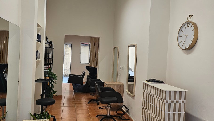 Elegant interior of Tracy Marie salon in Las Palmas De Gran Canaria, Canarias, ES, featuring styling stations.