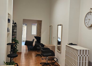 Elegant interior of Tracy Marie salon in Las Palmas De Gran Canaria, Canarias, ES, featuring styling stations.