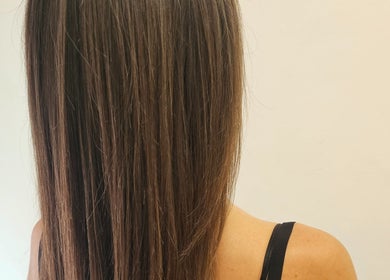 Smooth, shiny brown hair styled at Tracy Marie in Las Palmas De Gran Canaria, Canarias, ES.
