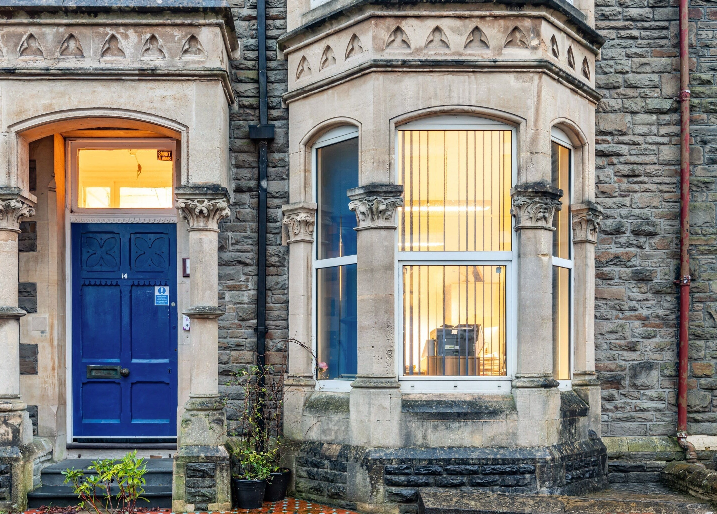 Charming facade of Luxe Beautè at Cardiff, Wales, GB showcasing classic architecture and inviting blue doors.
