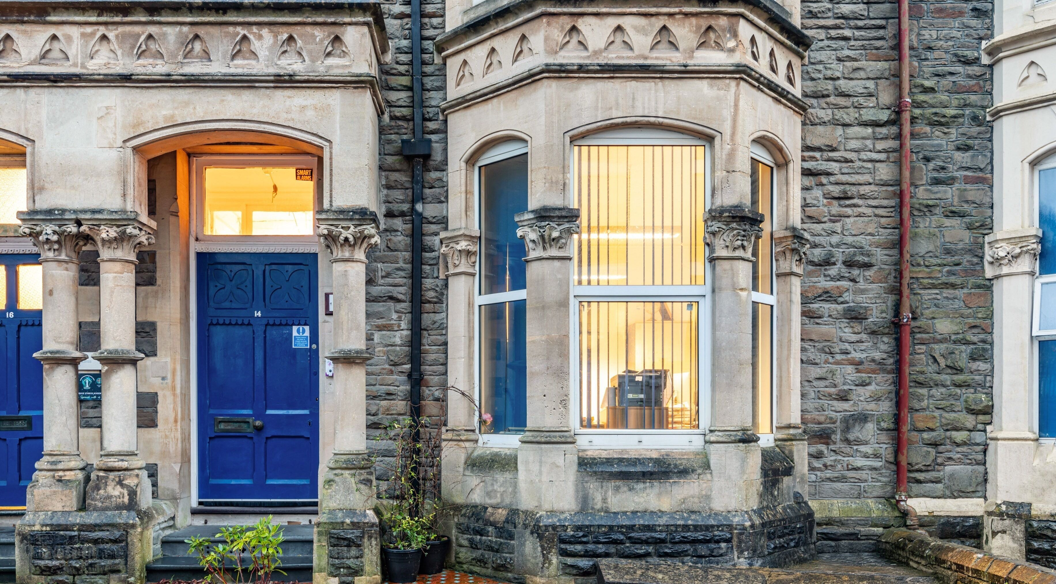 Charming facade of Luxe Beautè at Cardiff, Wales, GB showcasing classic architecture and inviting blue doors.