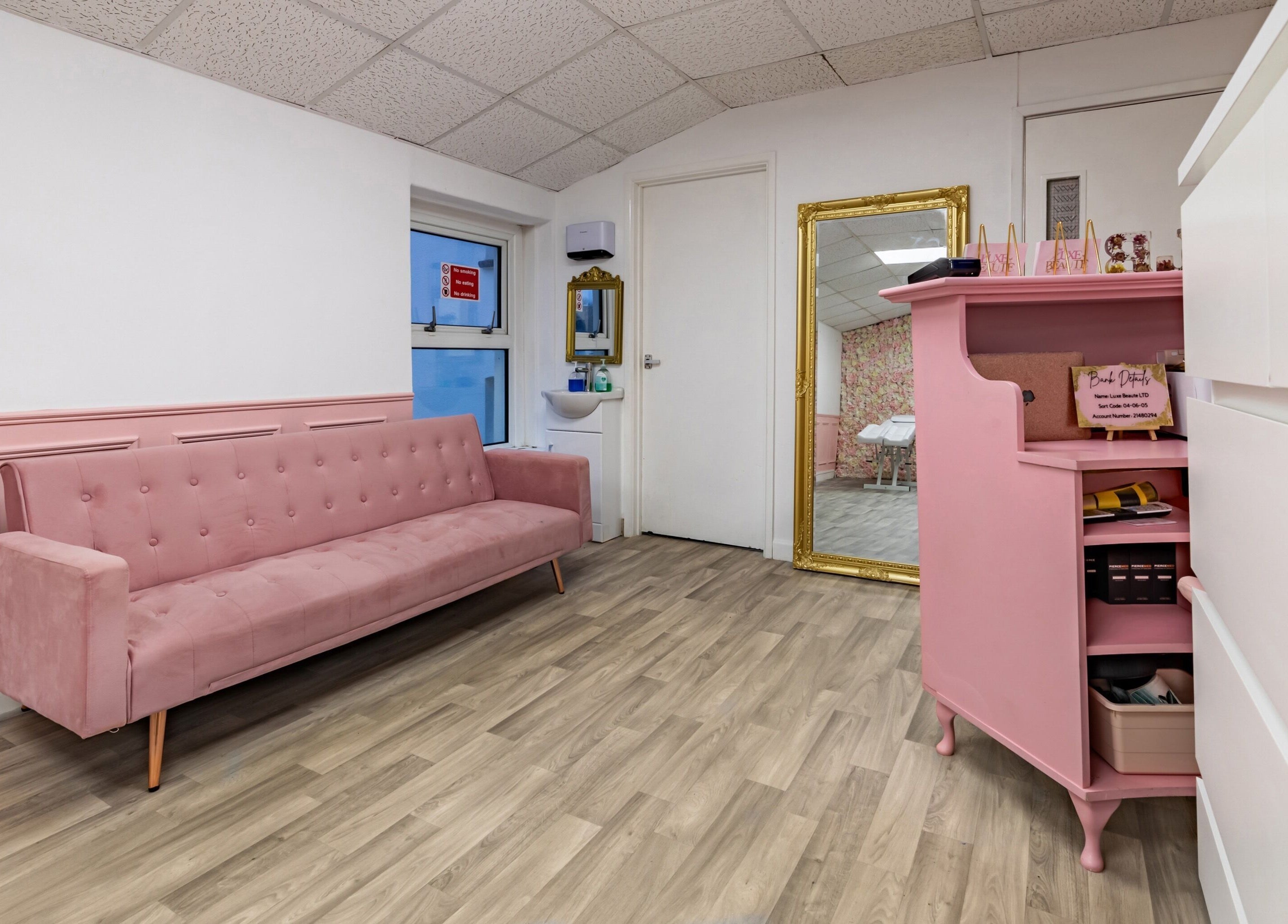 Elegant pink lounge area at Luxe Beautè, Cardiff, Wales, GB, featuring chic decor and inviting seating.