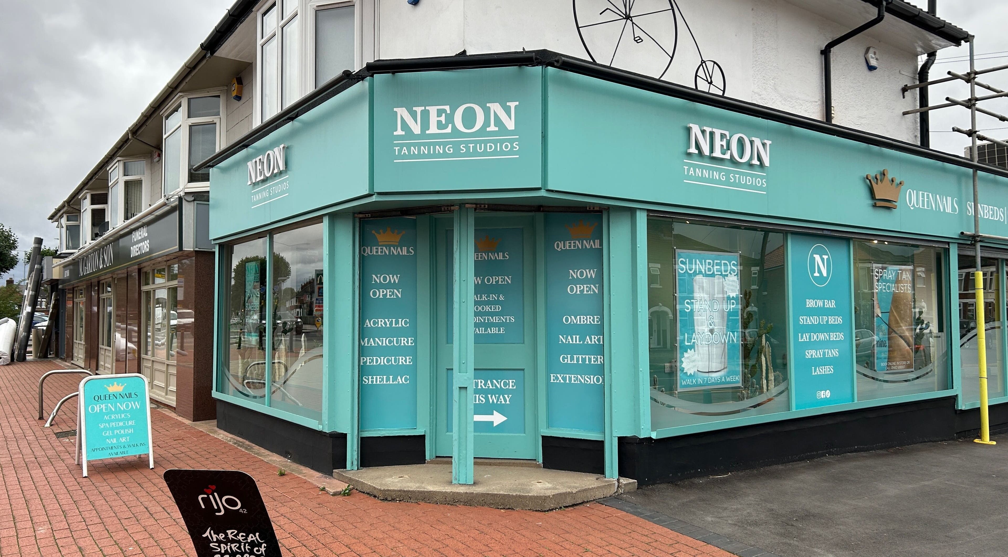 Queen Nails storefront in Hull, England, GB offering manicures, pedicures, and more in a vibrant setting.