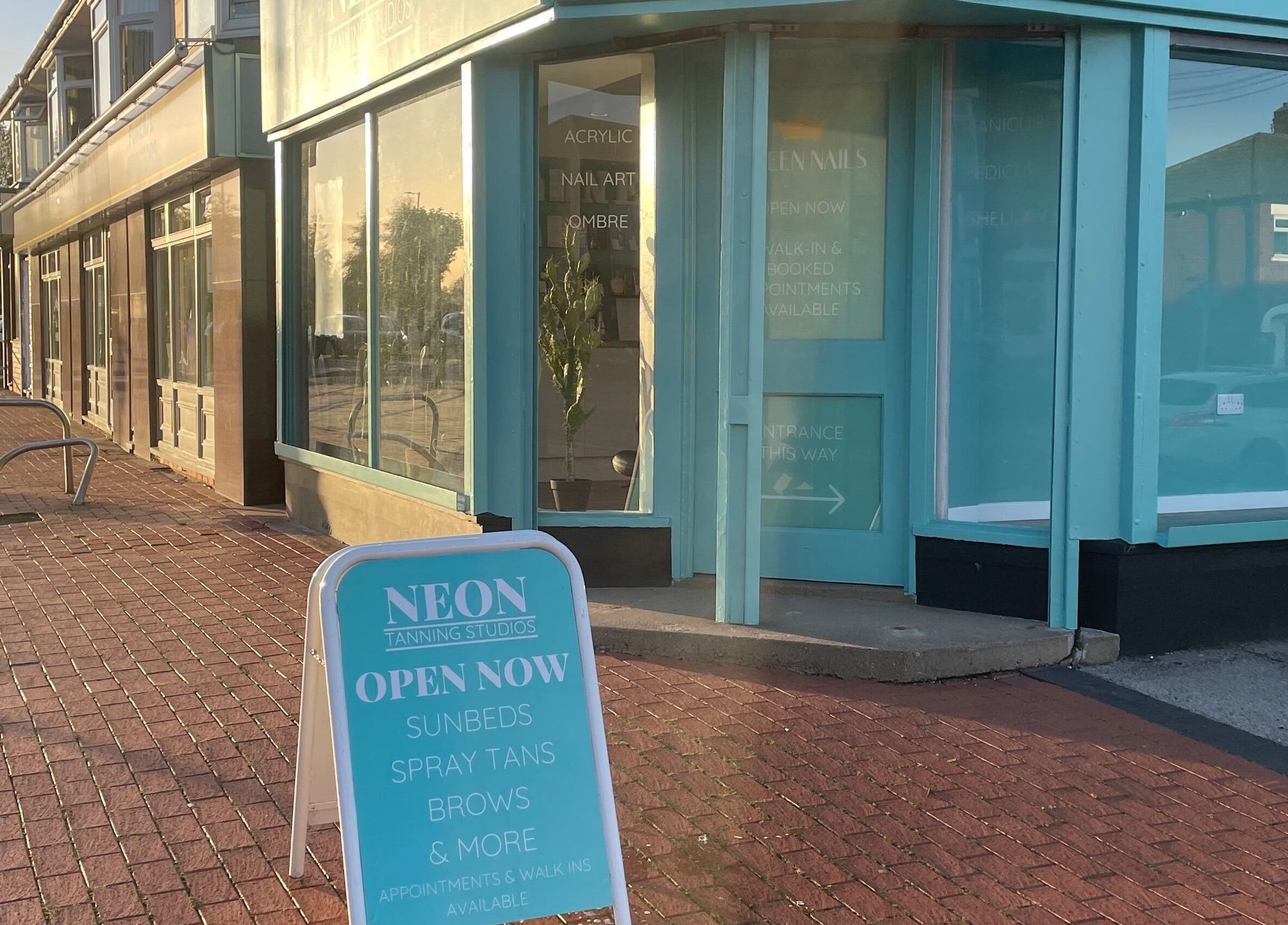 Entrance of Queen Nails, a chic beauty venue in Hull, England, GB, with signage advertising sunbeds and tanning.