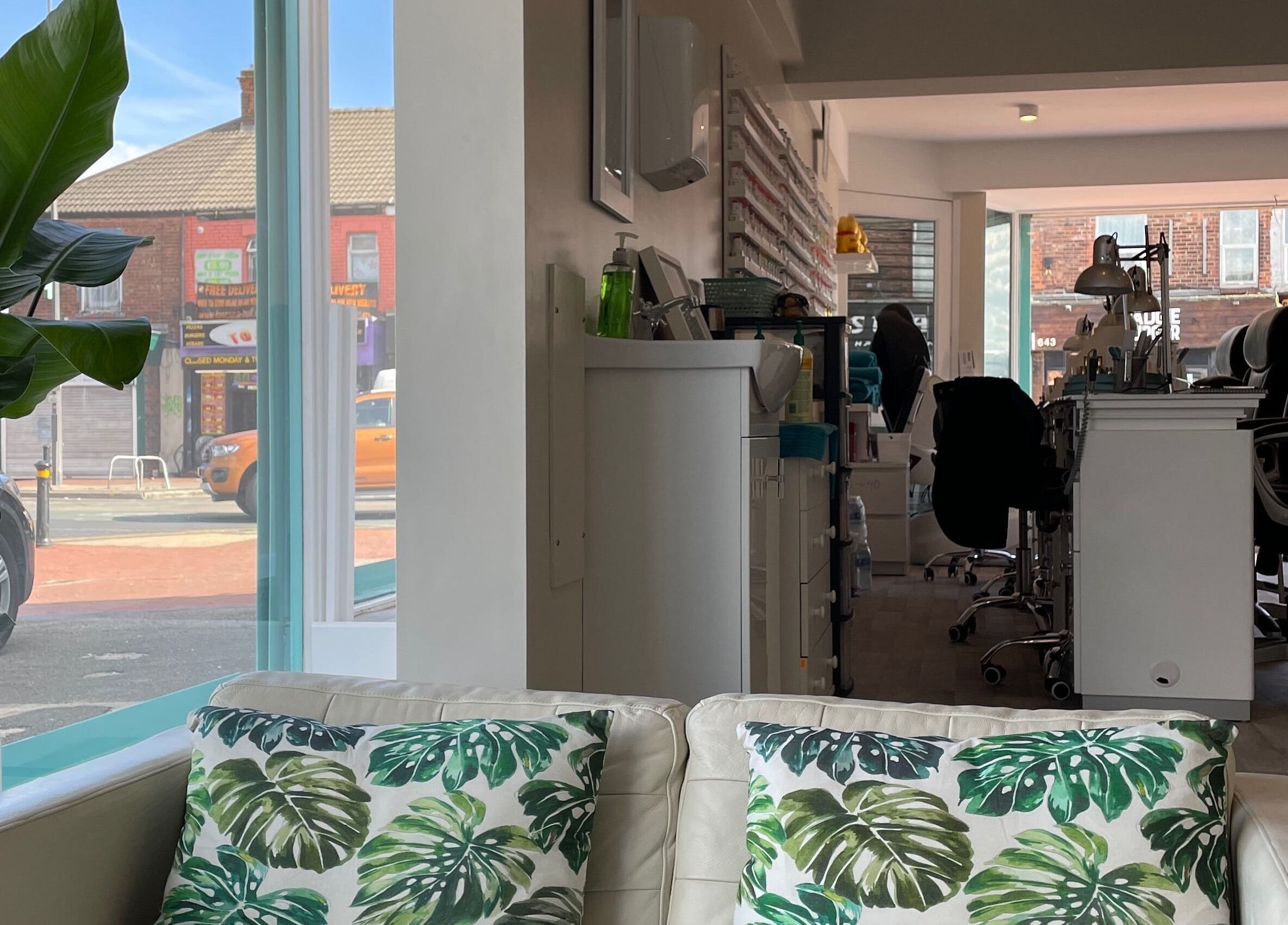 Cozy interior of Queen Nails in Hull, England, GB showcasing stylish seating and nail stations.