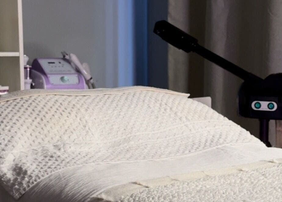 Spa room at After Glow by Liv in Worsley, England, GB showcasing a massage bed and beauty equipment.