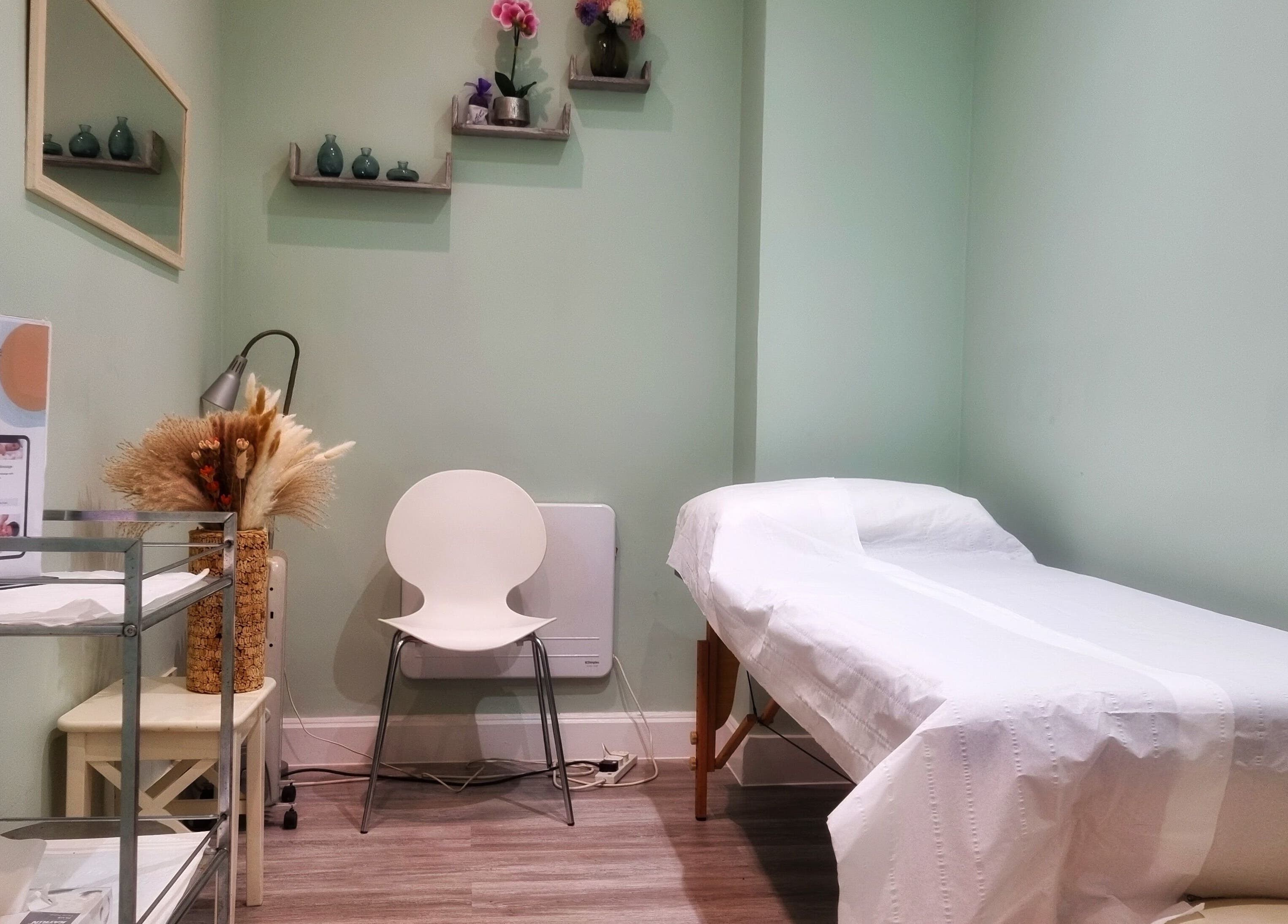 Calming therapy room at Ginger Natural Health, St Albans, England, GB, featuring treatment bed and soothing décor.