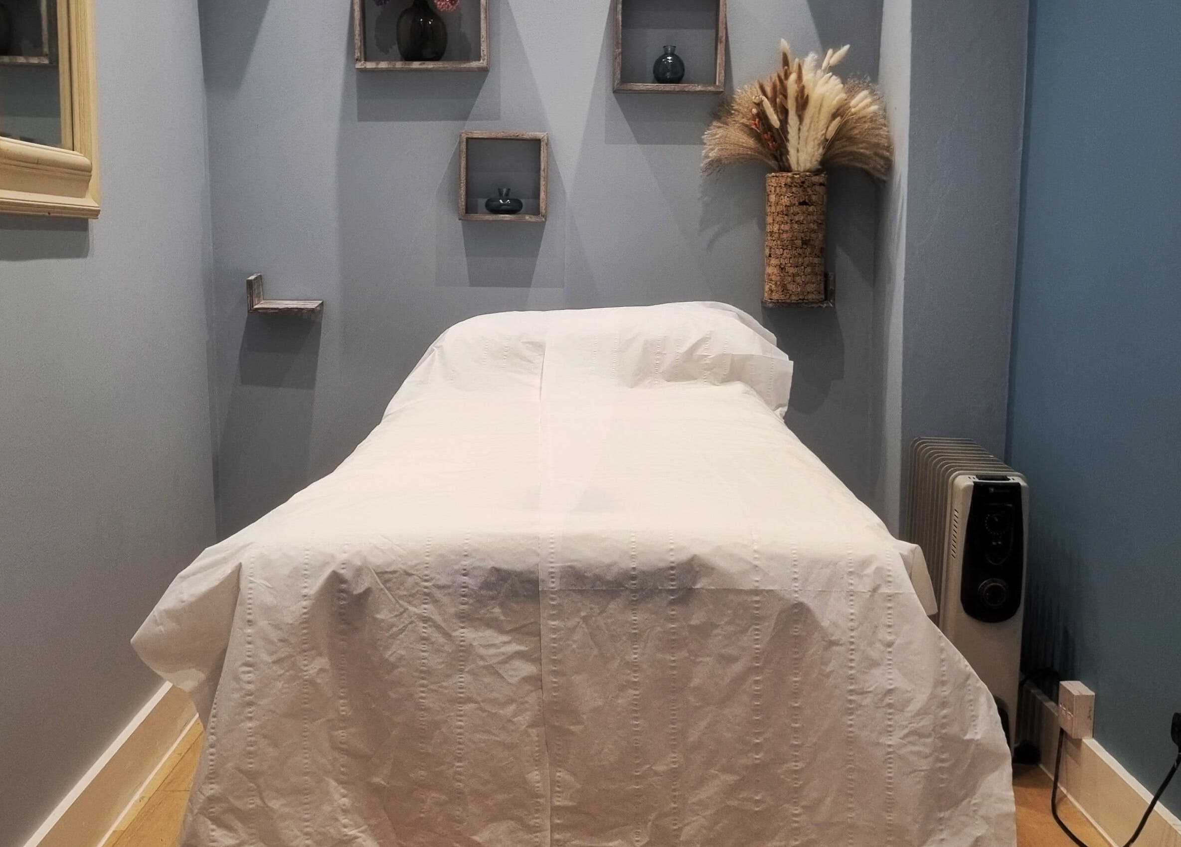 Treatment room at Ginger Natural Health, St Albans, England, GB, featuring a massage bed and calming decor.