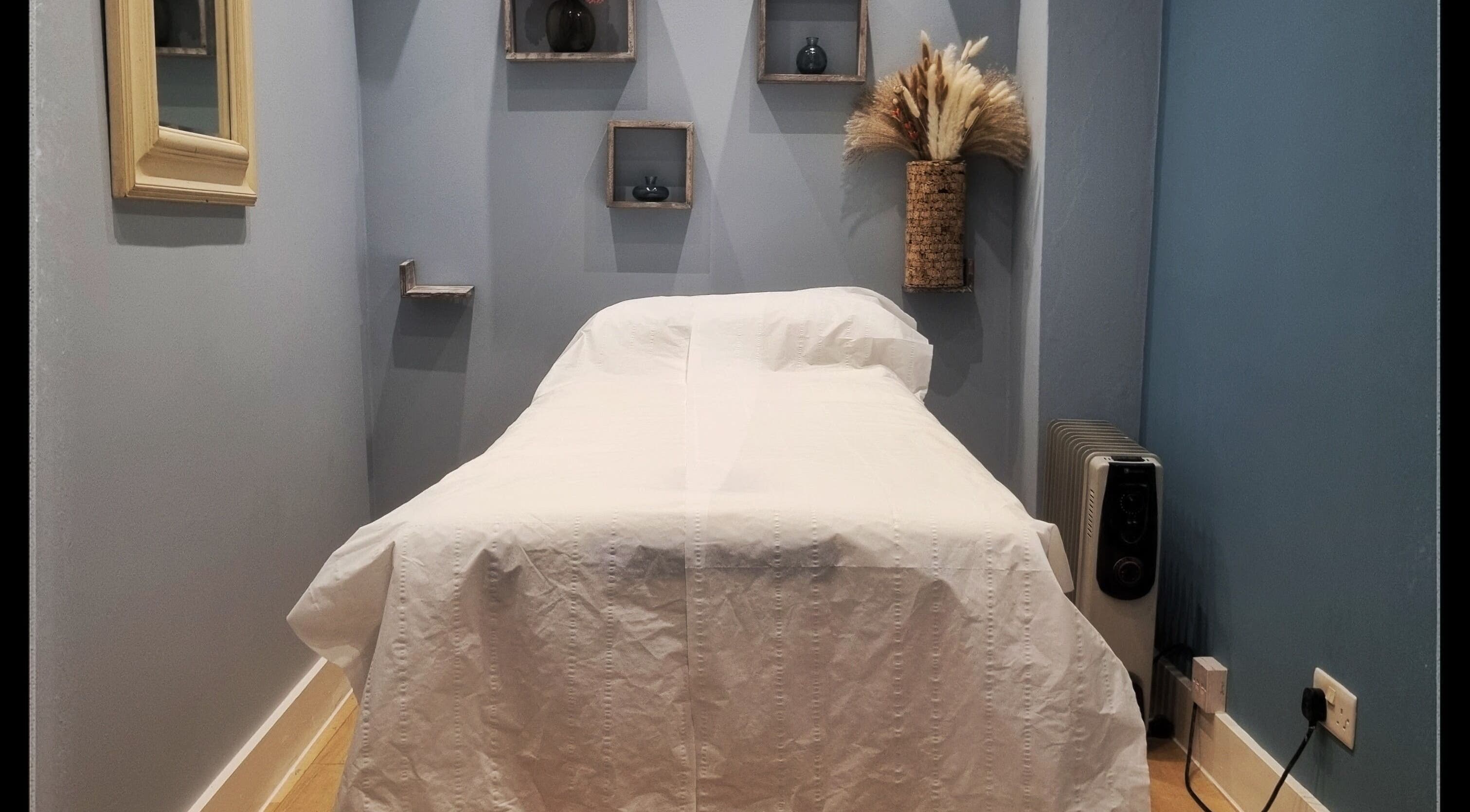 Treatment room at Ginger Natural Health, St Albans, England, GB, featuring a massage bed and calming decor.