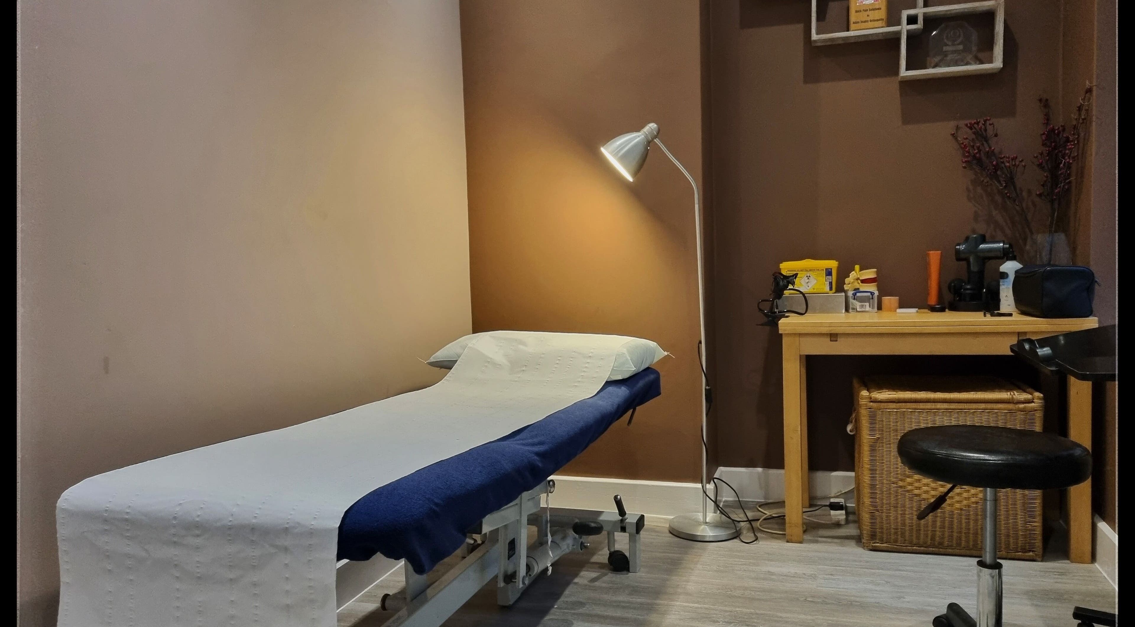 Cozy treatment room at Ginger Natural Health, St Albans, England, GB with massage table and decor.