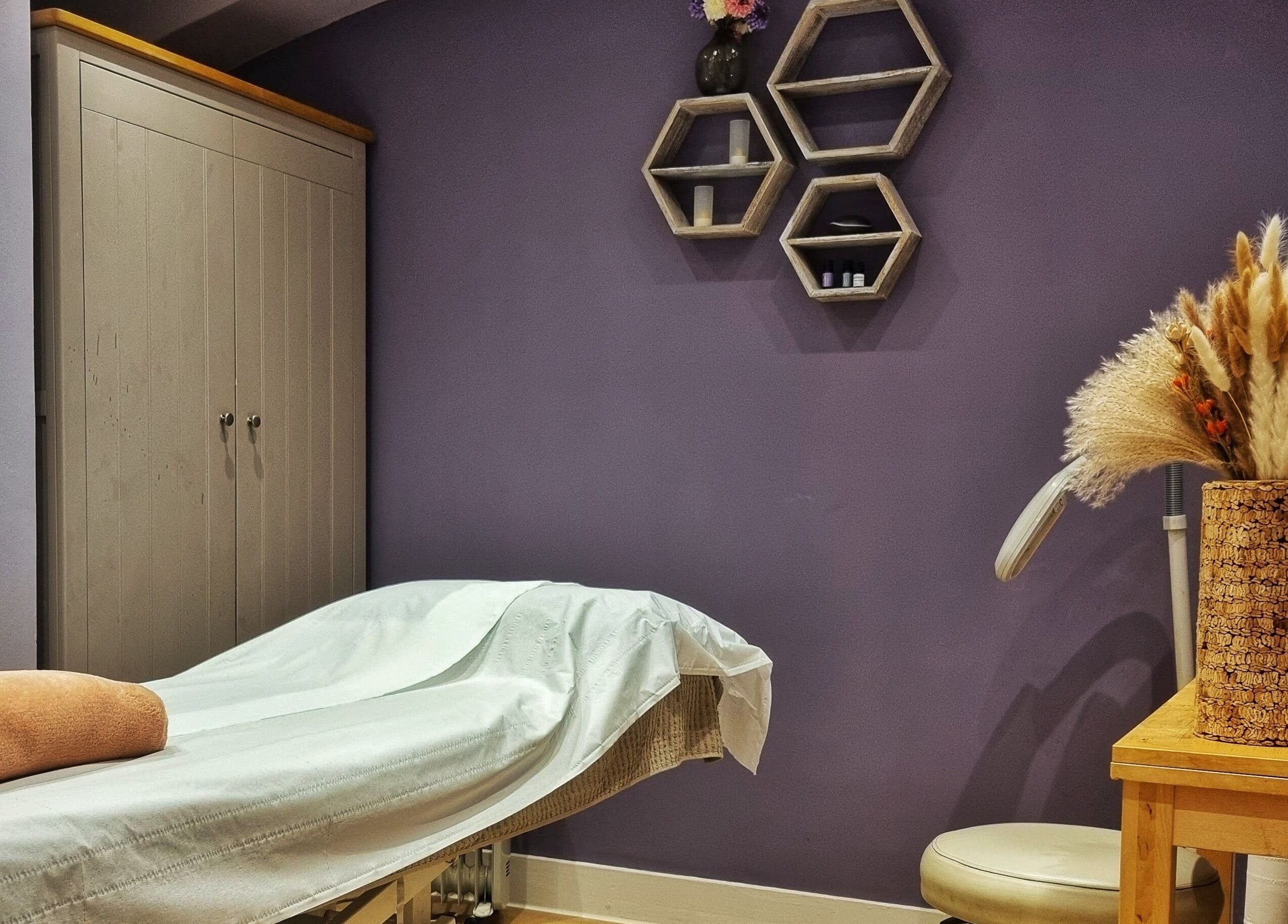 Tranquil treatment room at Ginger Natural Health, St Albans, England, GB, with soothing decor and massage bed.