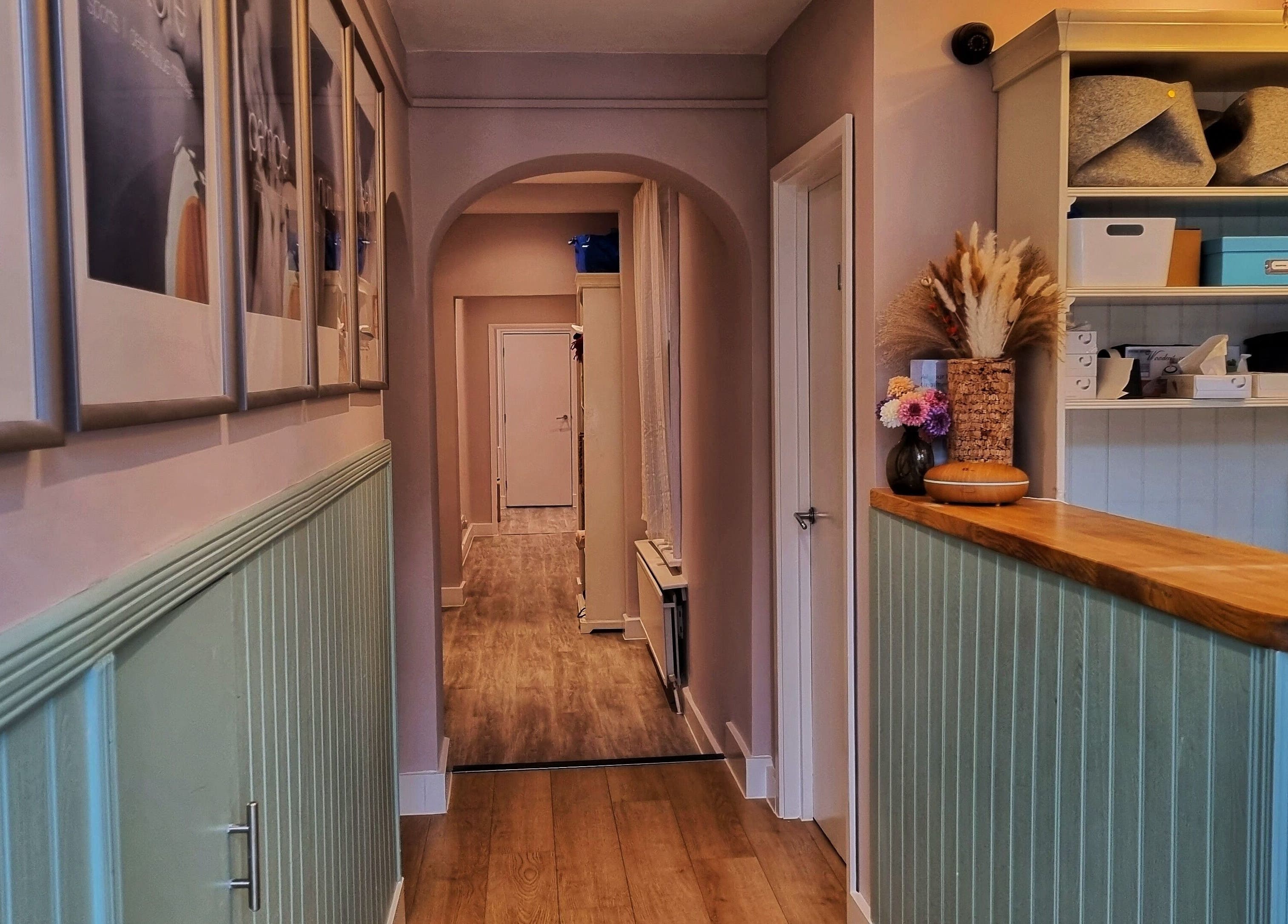 Charming interior hallway at Ginger Natural Health, St Albans, England, GB, featuring wooden floors and decor.