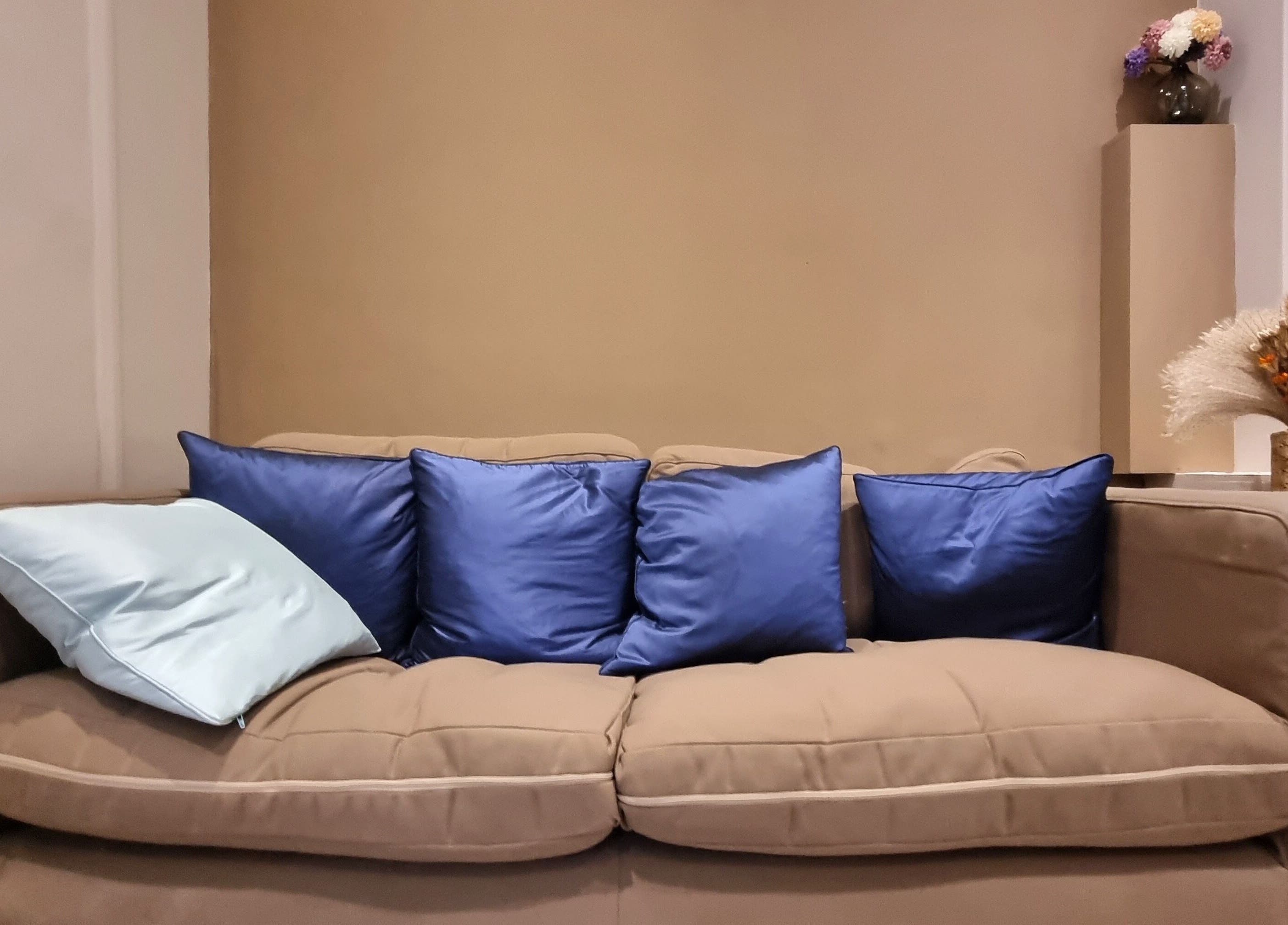 Plush sofa with blue cushions in a serene room at Ginger Natural Health, St Albans, England, GB.