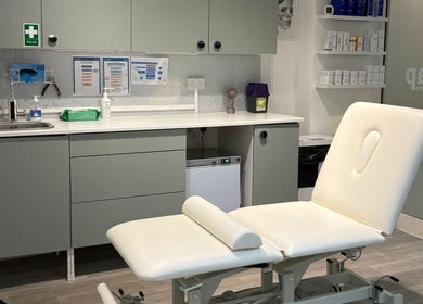 Clean and modern treatment room at Skintap, London, England, GB with a white treatment chair.