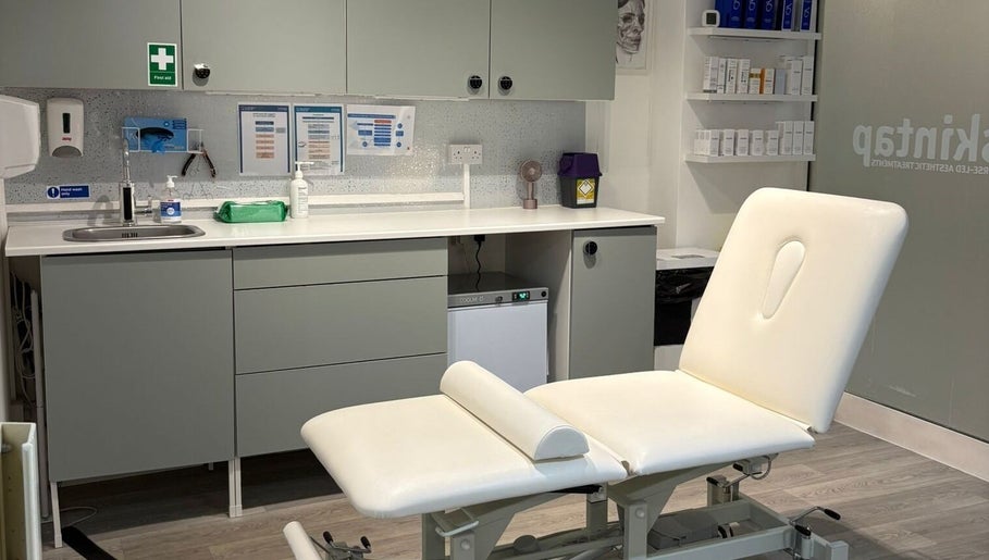 Modern treatment room at Skintap, London, England, GB with a comfortable spa bed and sleek cabinetry.