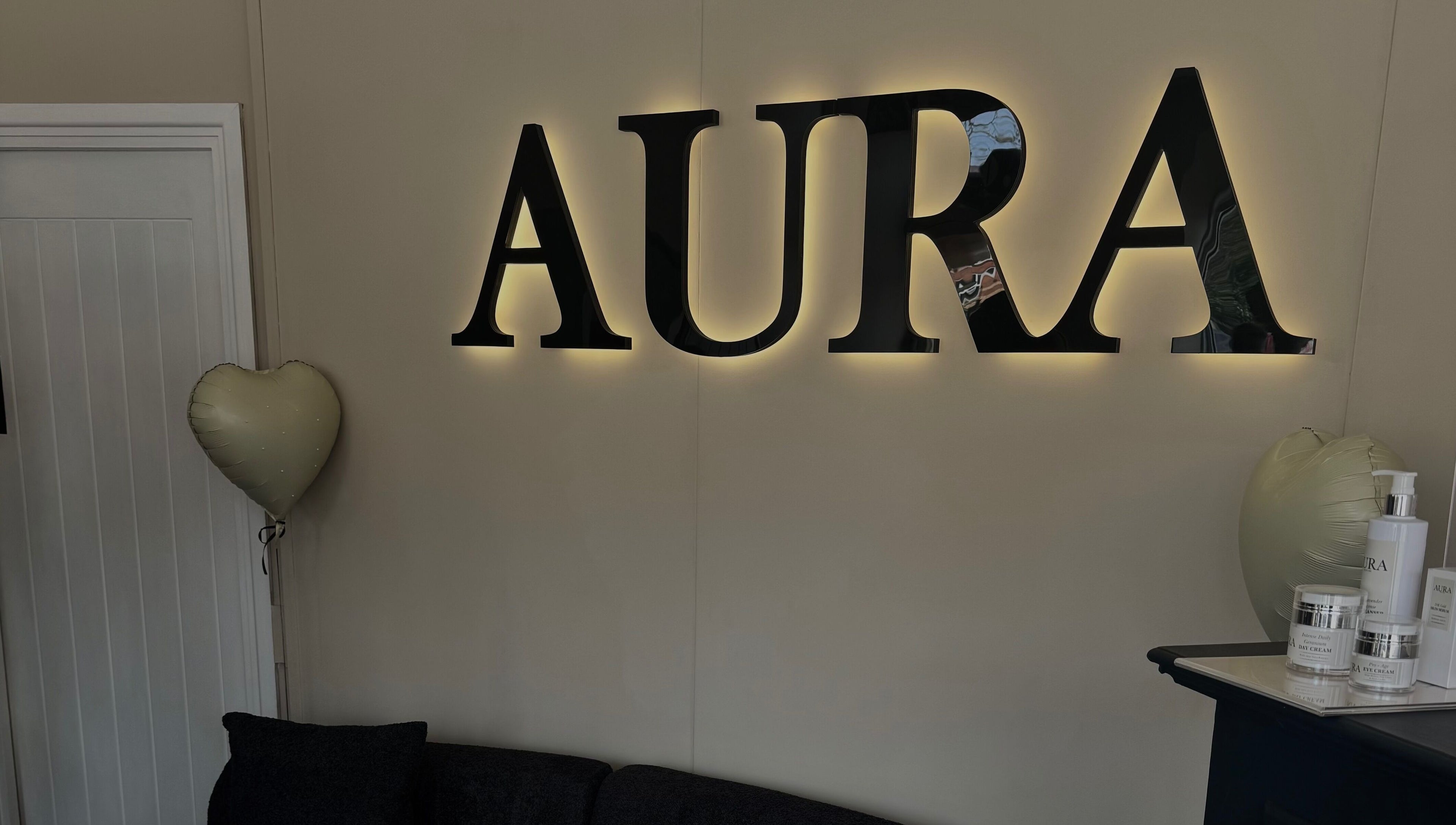 Illuminated Aura wall sign at By Paris Warren, Hucknall, England, GB. Heart balloon and products on display.