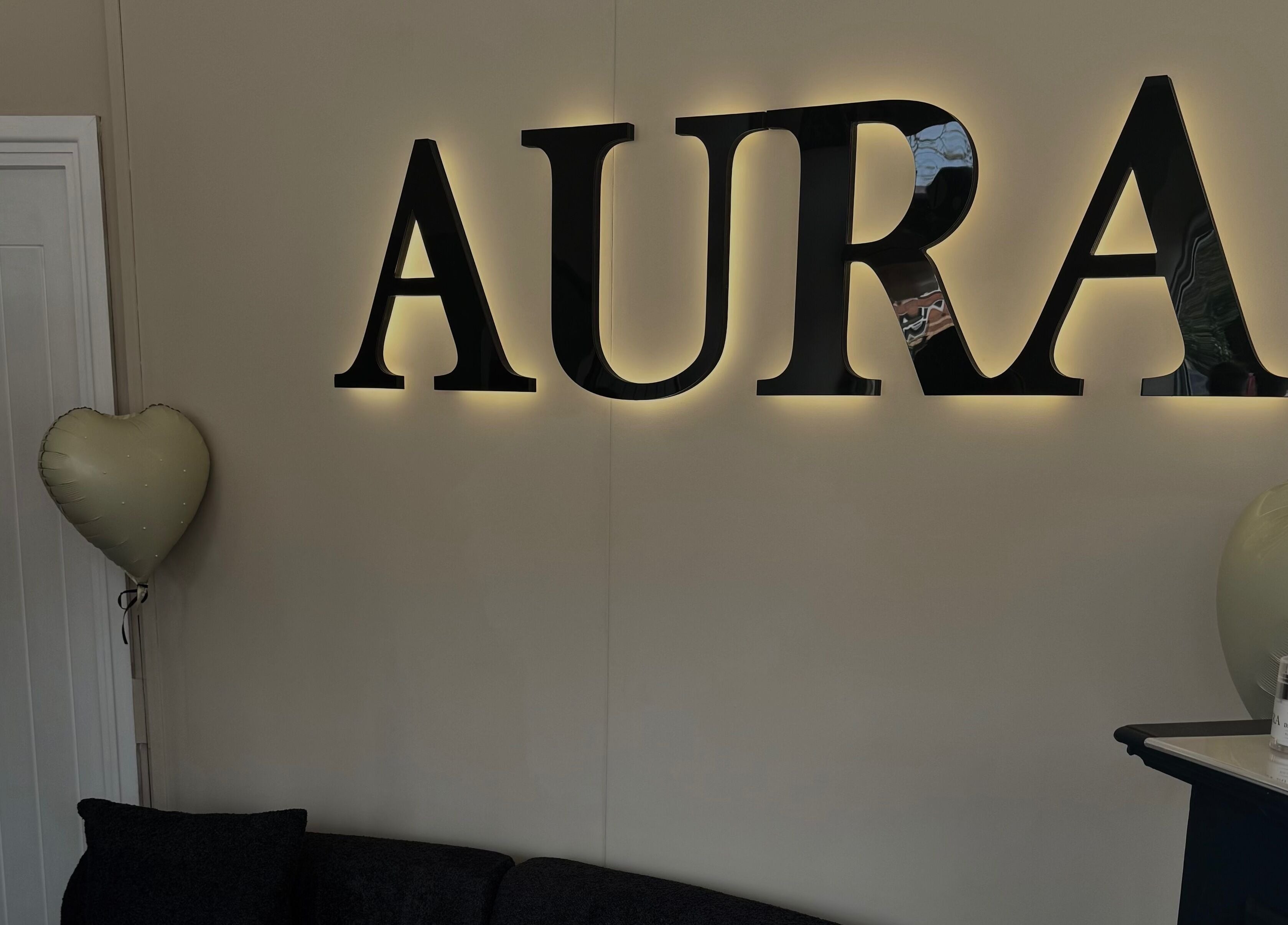 Illuminated Aura wall sign at By Paris Warren, Hucknall, England, GB. Heart balloon and products on display.