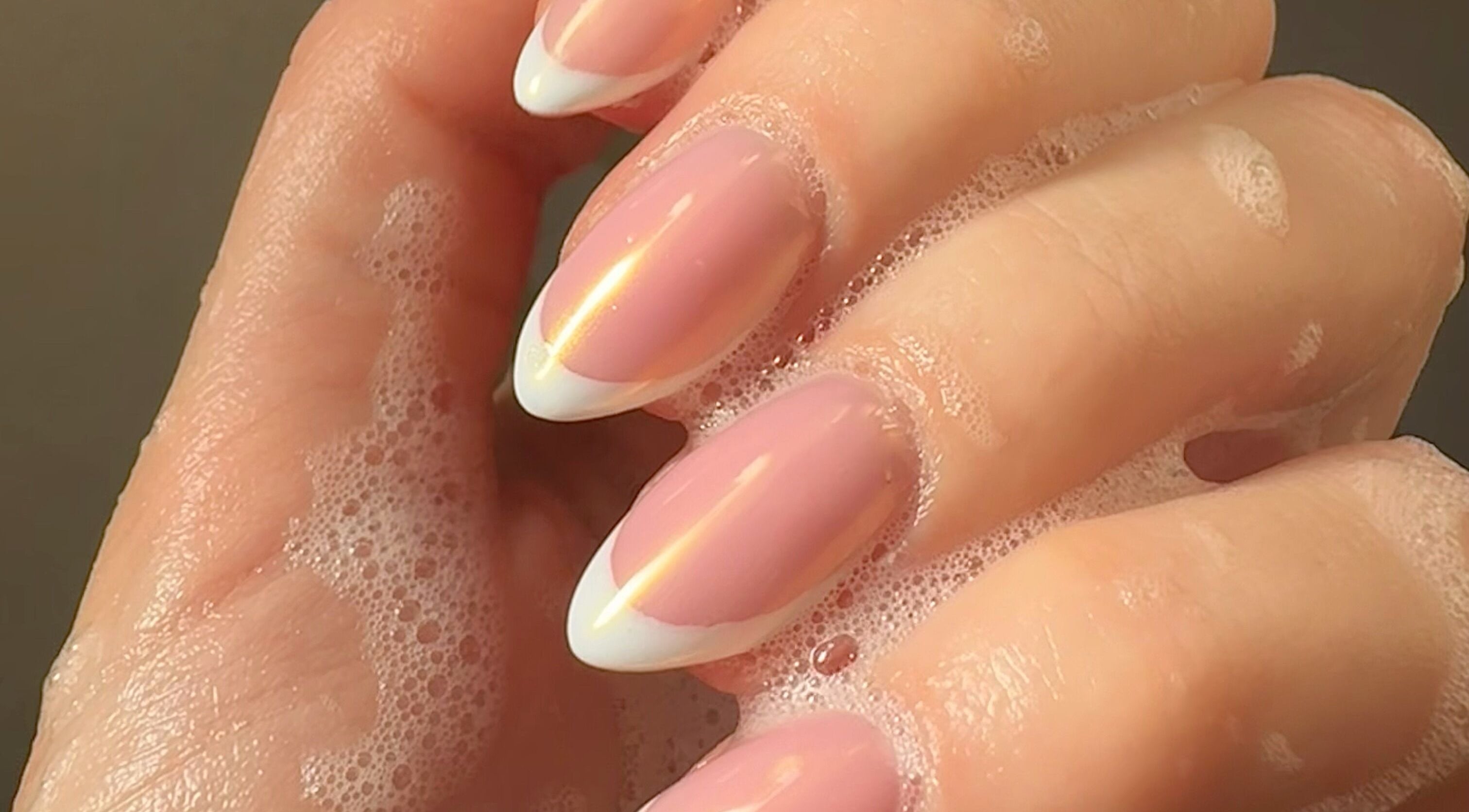Chic French manicure with soap bubbles at By Paris Warren, Hucknall, England, GB for elegant nail care.