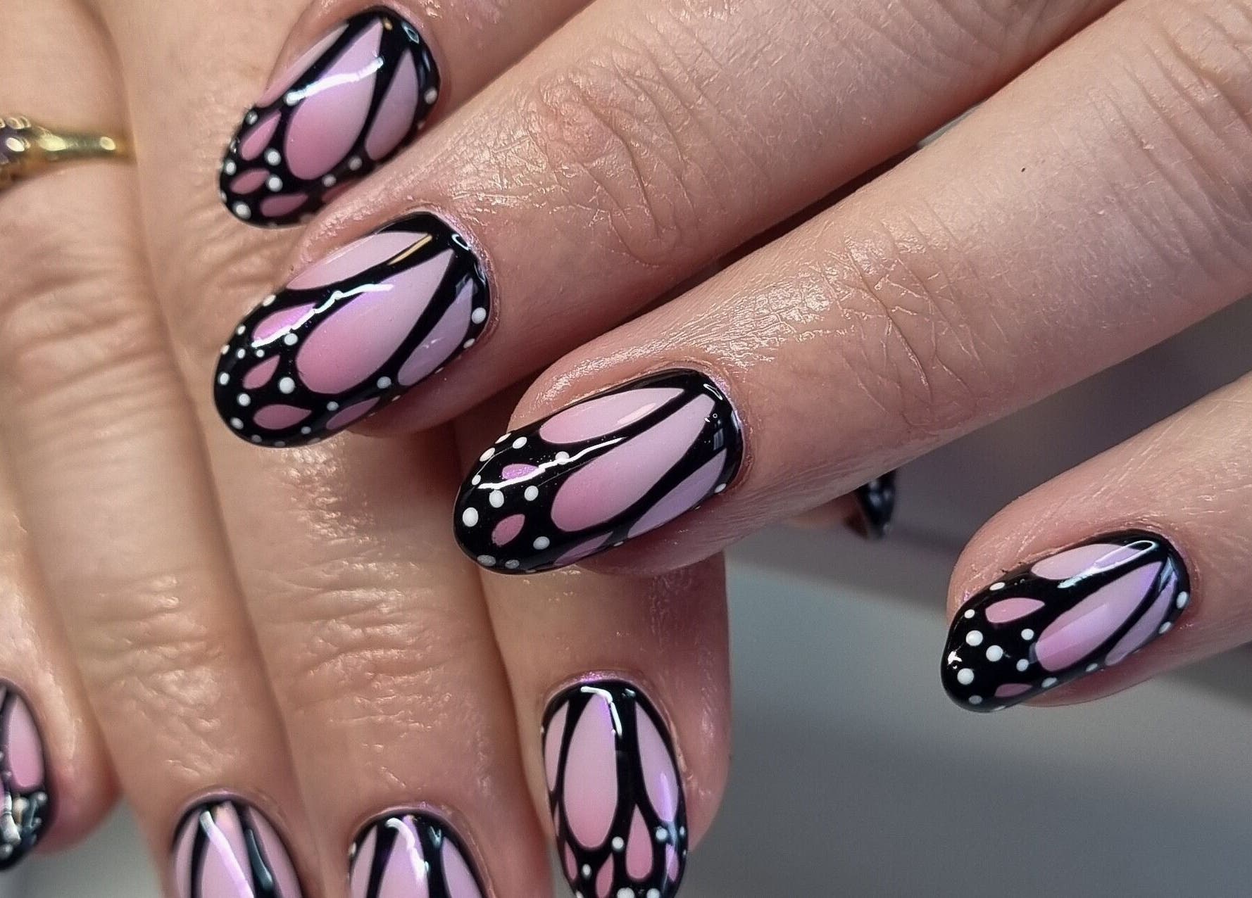 Elegant butterfly-themed nail art at Clawed Nail Studio, Pukekohe, Waikato, NZ, showcasing unique design flair.