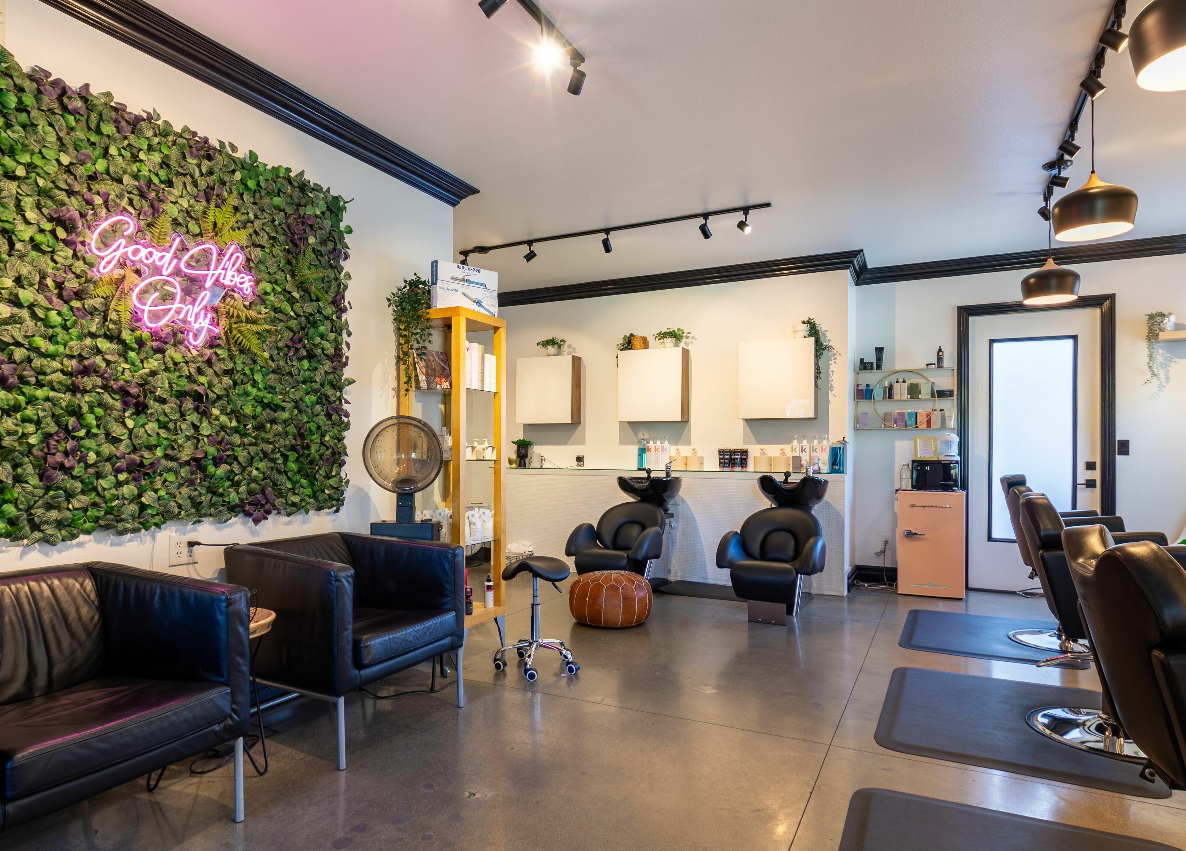 Stylish interior of Red Door Salon with Aimee in Ladera Ranch, California, featuring modern decor and lush greenery.