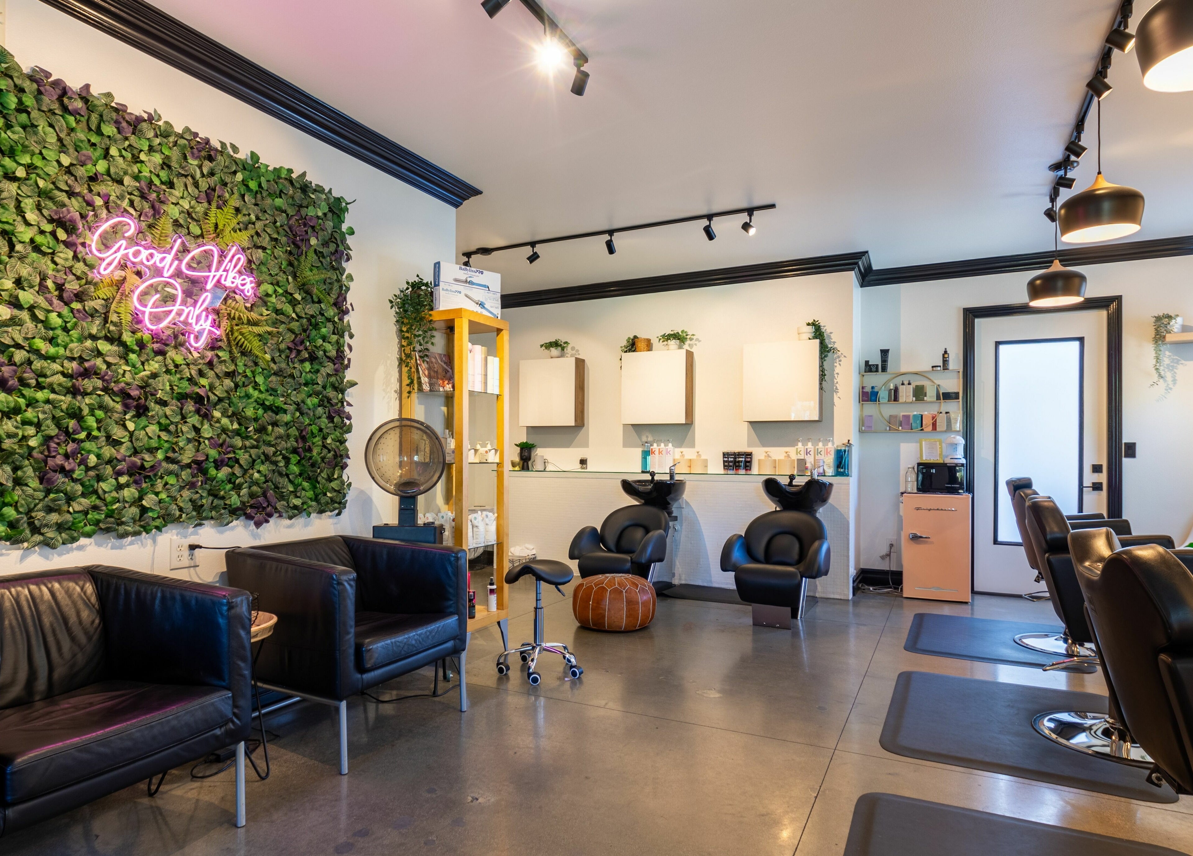 Stylish interior of Red Door Salon with Aimee in Ladera Ranch, California, featuring modern decor and lush greenery.