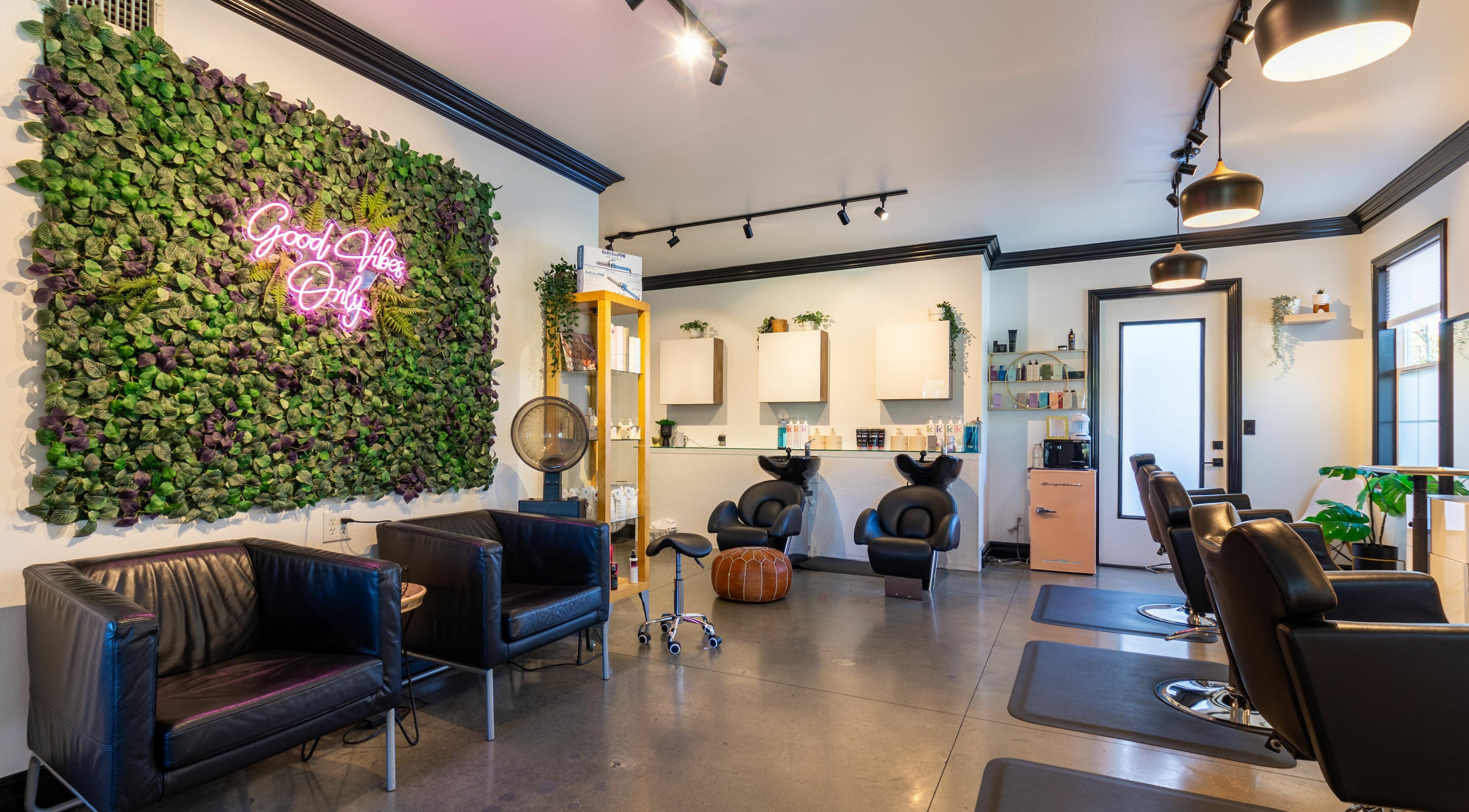 Stylish interior of Red Door Salon with Aimee in Ladera Ranch, California, featuring modern decor and lush greenery.