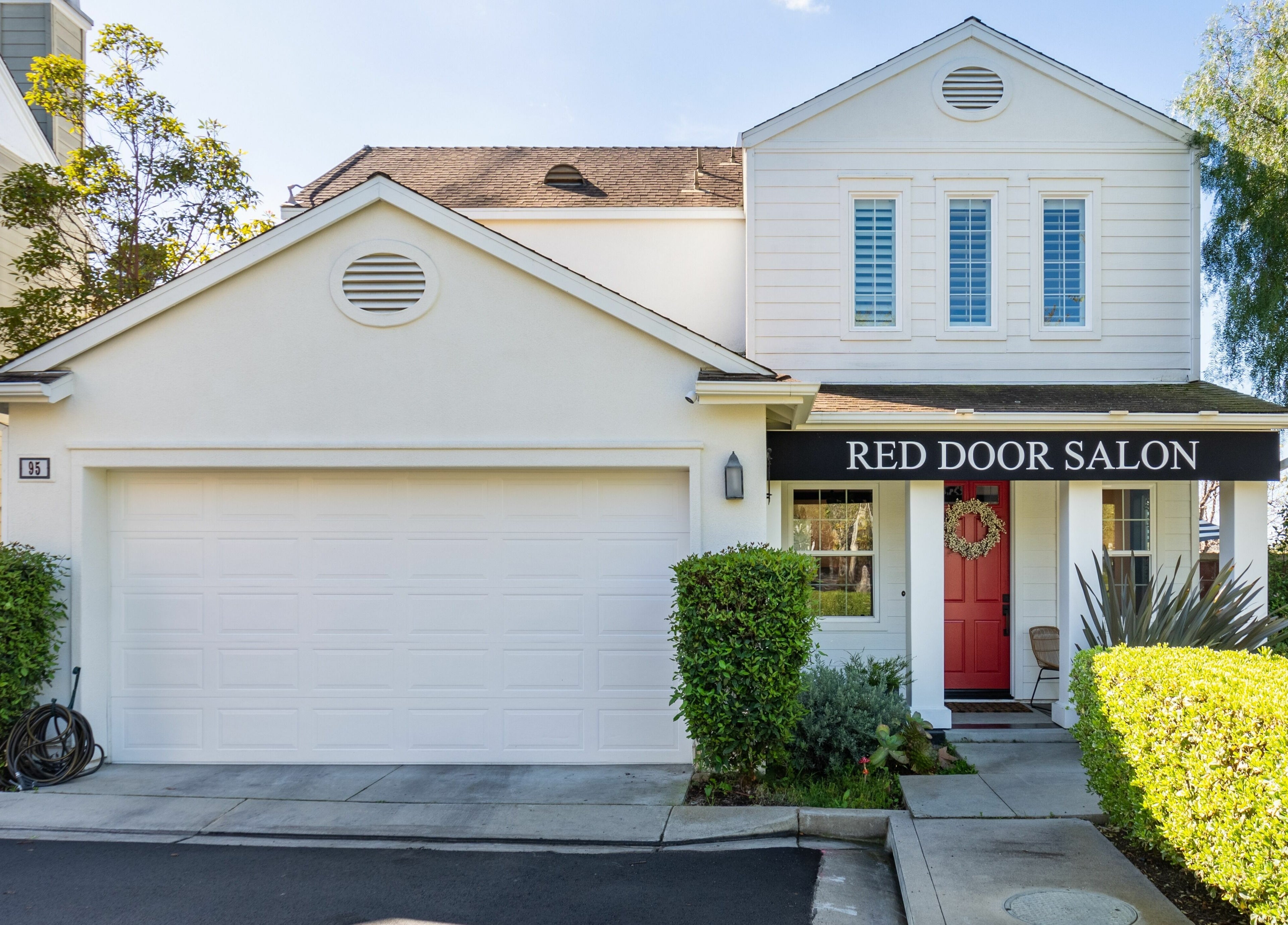 Front view of Red Door Salon with Aimee, Ladera Ranch, California, featuring a welcoming red door.