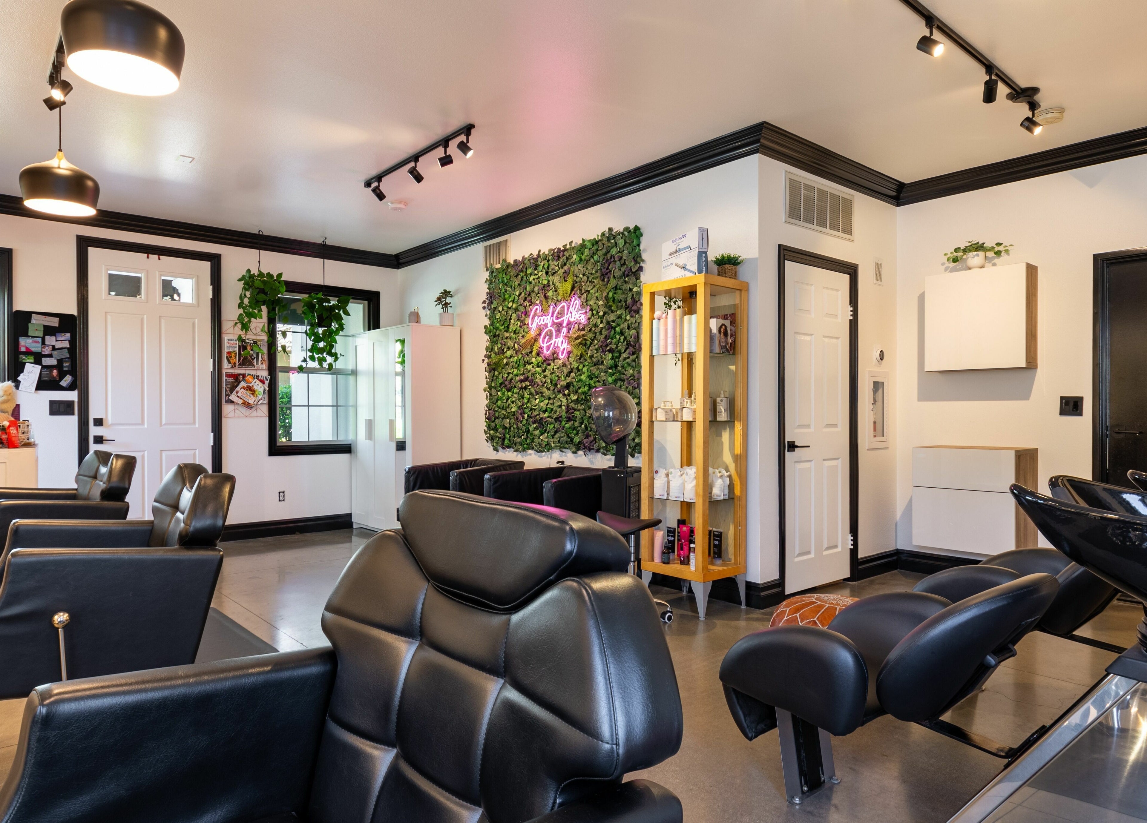Modern salon interior at Red Door Salon with Aimee in Ladera Ranch, California, US features sleek styling chairs.