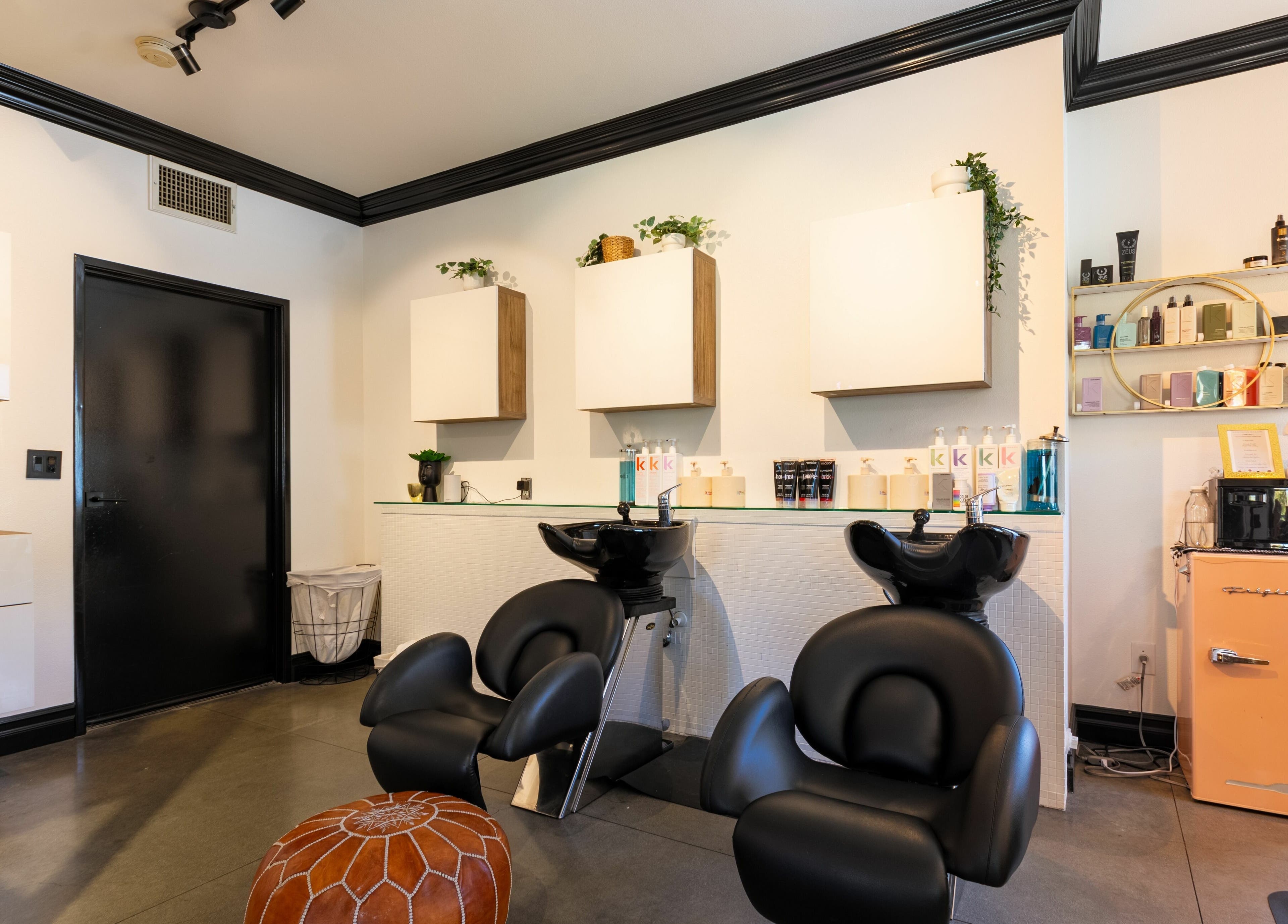 Modern interior of Red Door Salon with Aimee in Ladera Ranch, California featuring sleek hair stations.