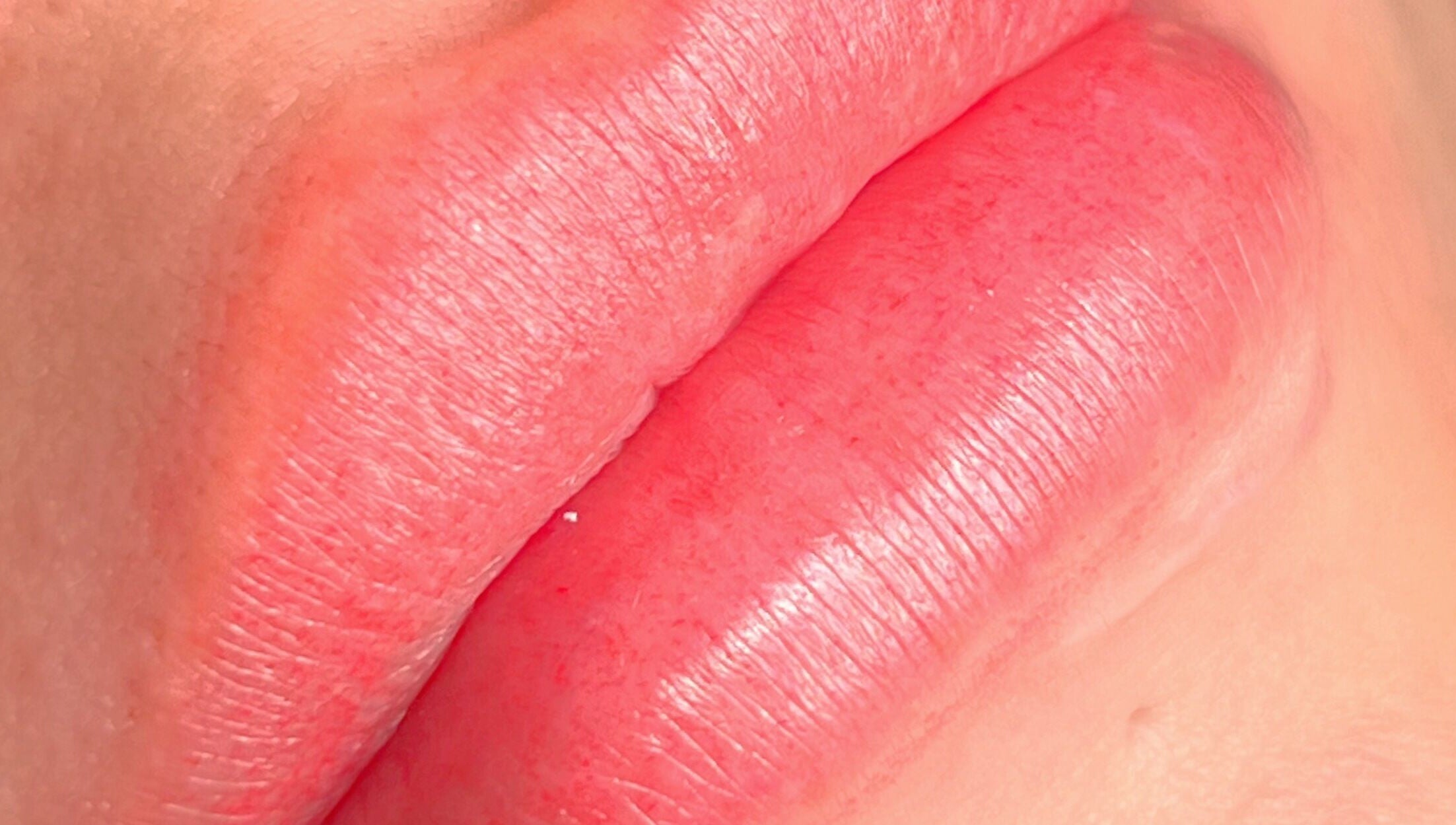 Closeup of beautifully enhanced lips at Yuna Uchoa, Dublin, County Dublin, IE. Natural pink hue and smooth texture.
