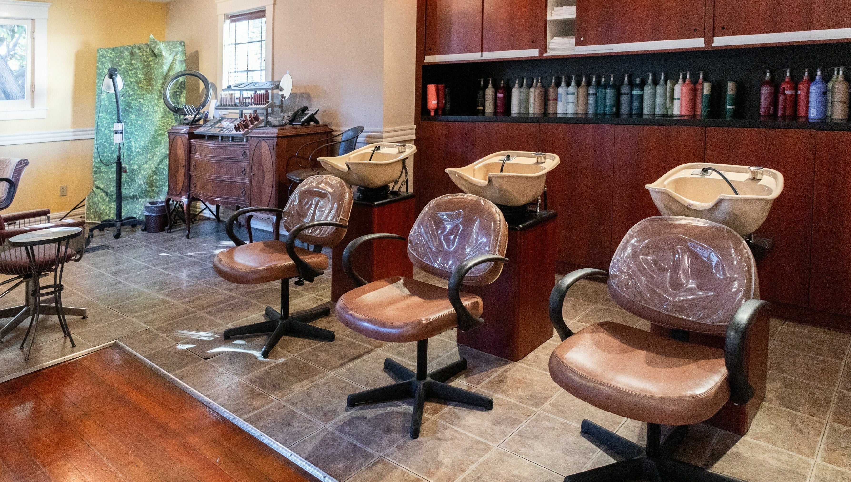 Spacious interior of Salon Benardo with styling chairs and sinks in Fullerton, California, US.