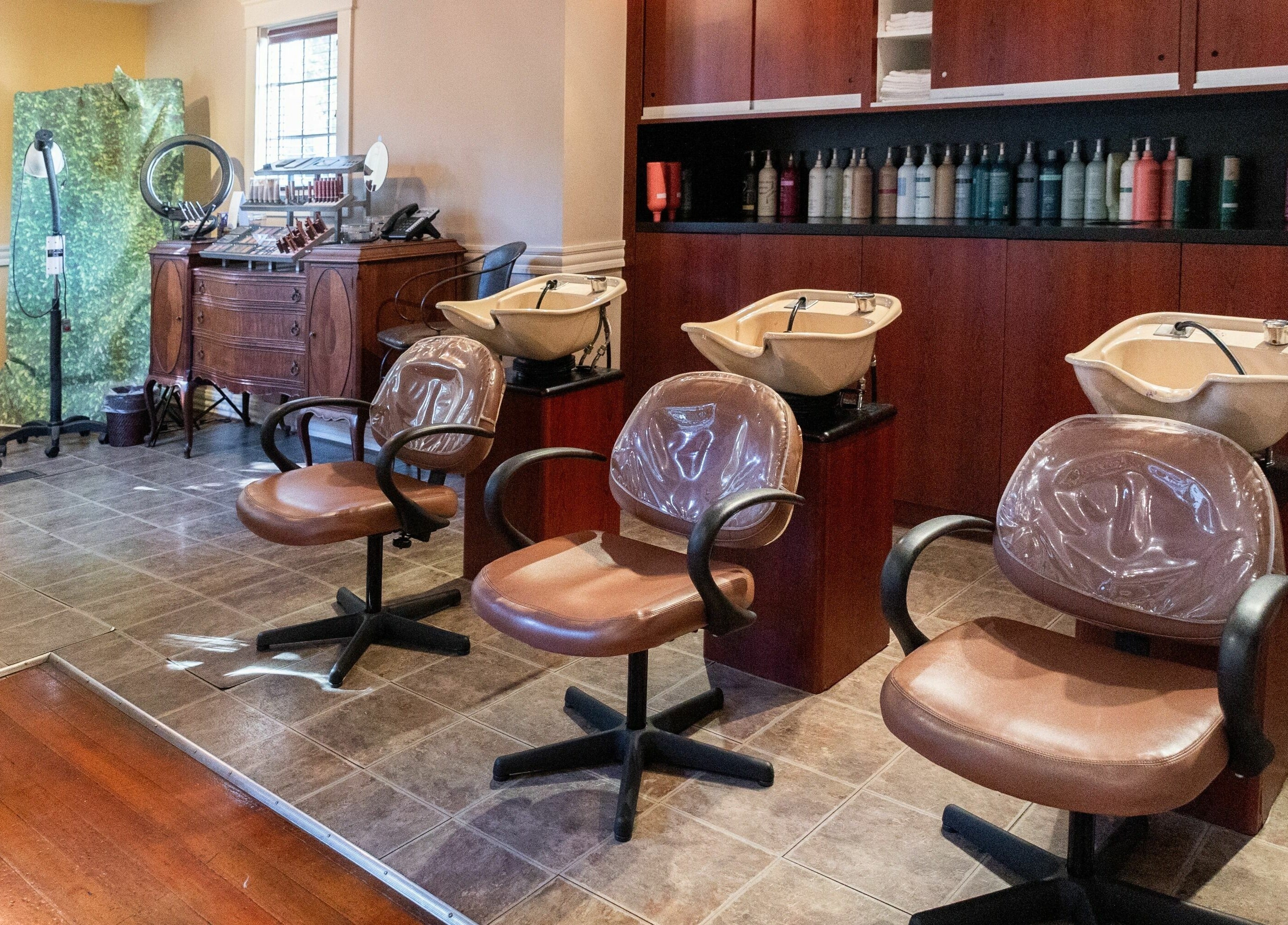 Spacious interior of Salon Benardo with styling chairs and sinks in Fullerton, California, US.