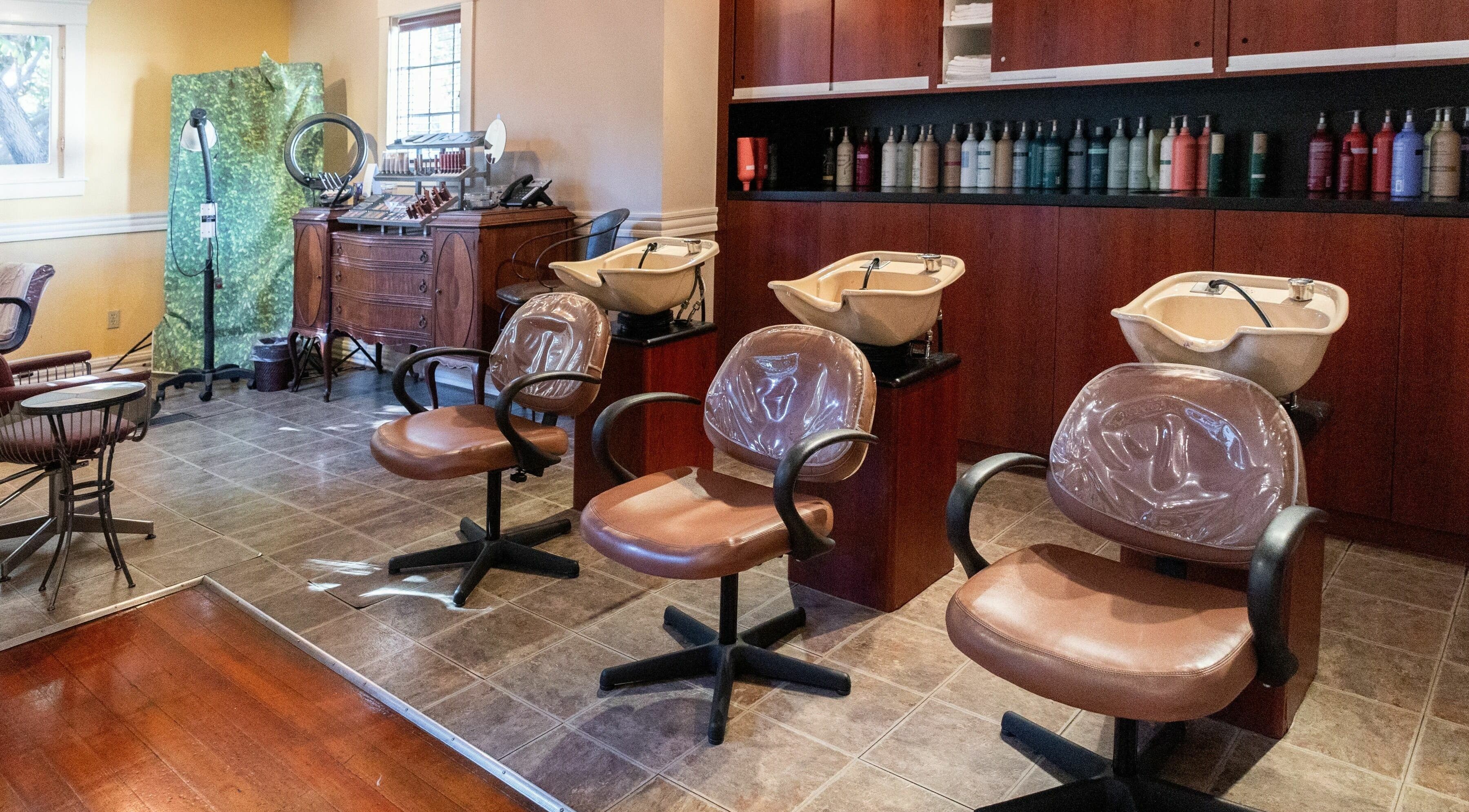 Spacious interior of Salon Benardo with styling chairs and sinks in Fullerton, California, US.