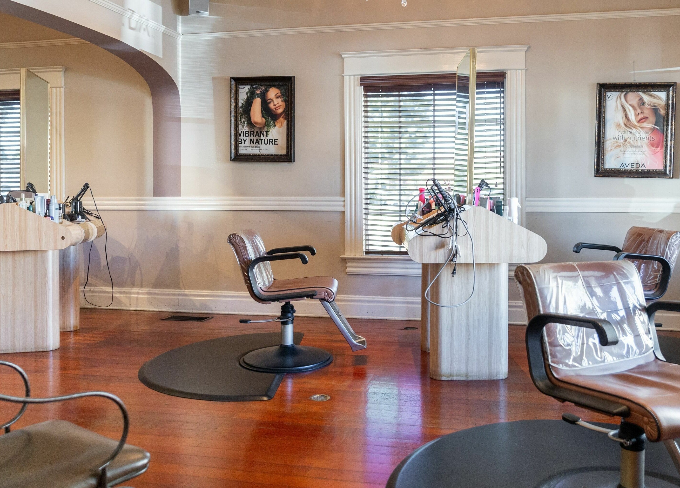 Modern salon interior at Salon Benardo, Fullerton, California, US, featuring stylish chairs and wooden décor.