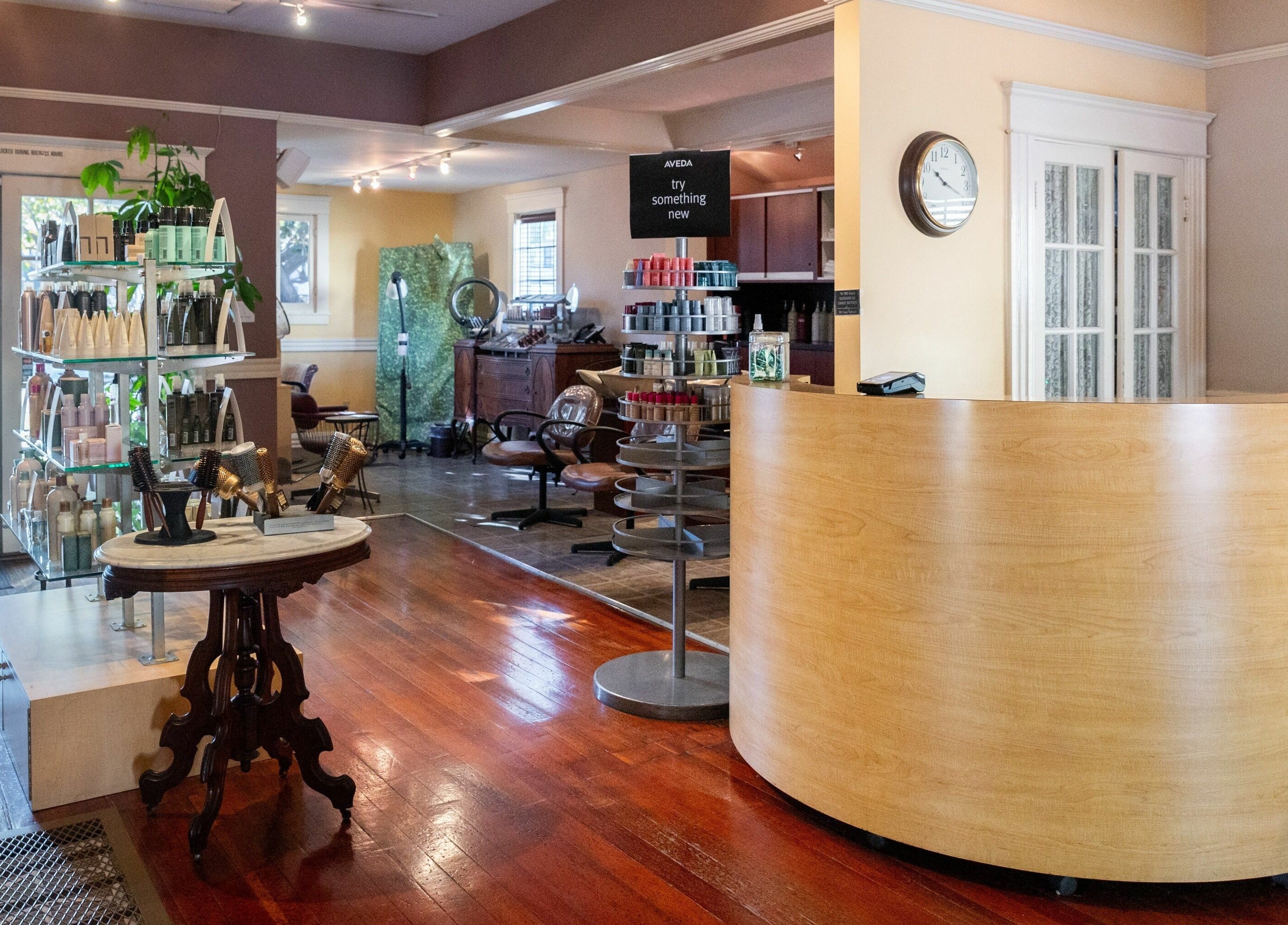 Modern reception area at Salon Benardo in Fullerton, California, US with stylish decor and beauty products display.