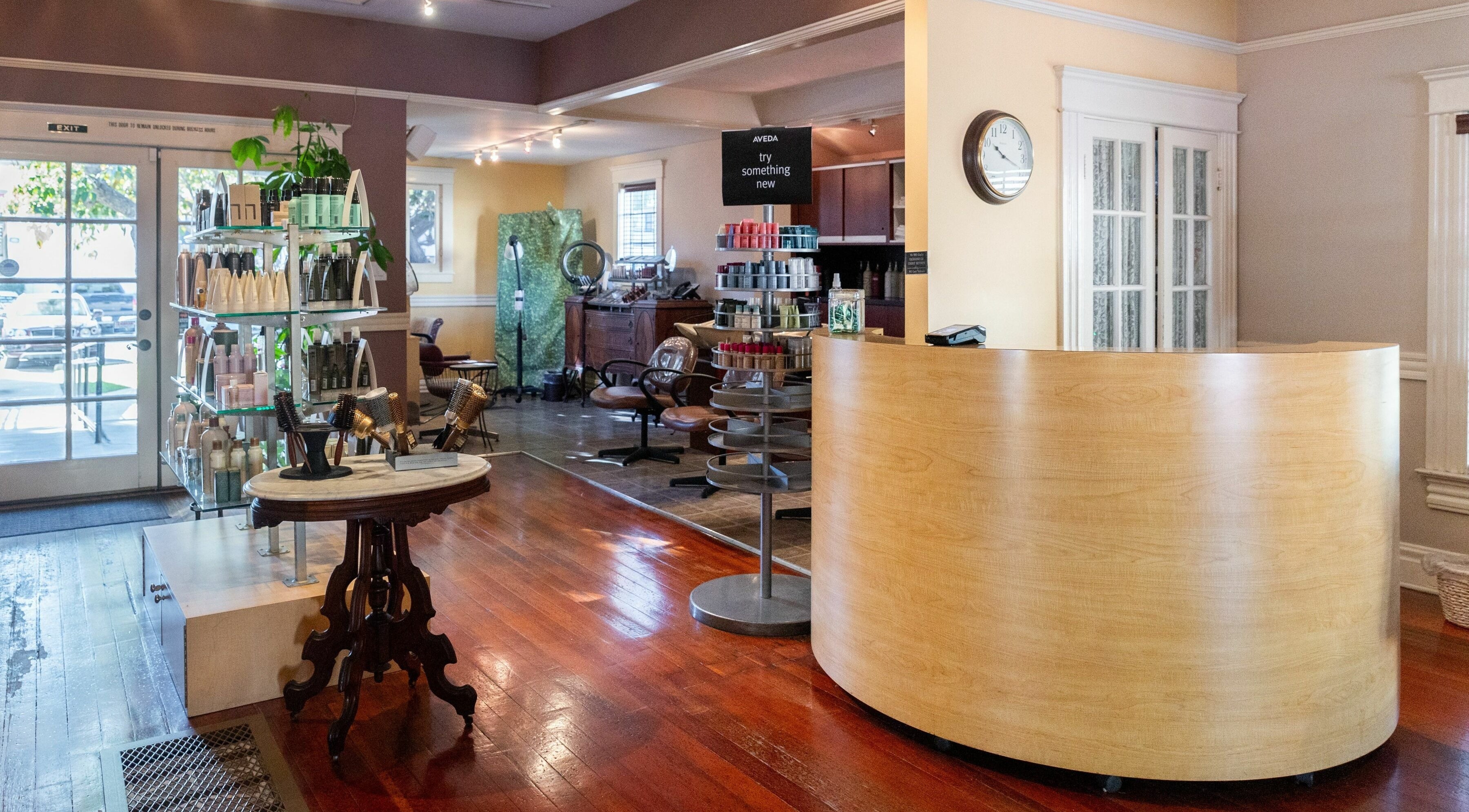 Modern reception area at Salon Benardo in Fullerton, California, US with stylish decor and beauty products display.