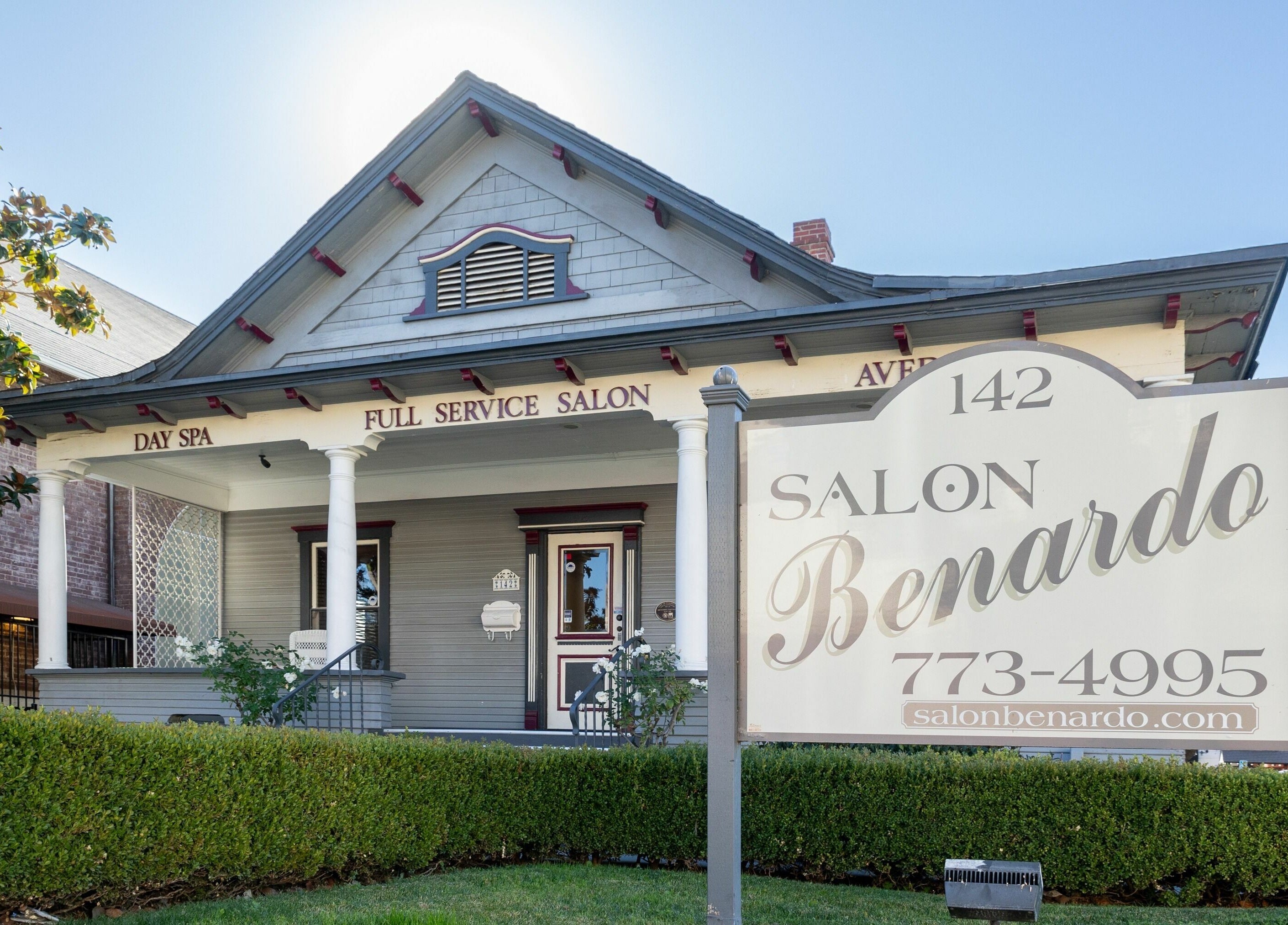 Charming exterior of Salon Benardo in Fullerton, California, US, showcasing a welcoming porch and signage.
