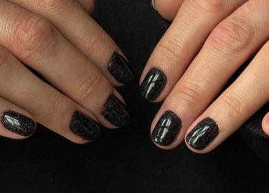 Elegantly manicured black nails with glitter at Polished Atelier, Surry Hills, Sydney, New South Wales, AU.