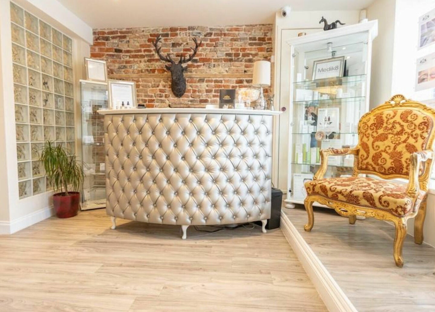 Luxurious reception area at High Grade House in Acle, England, GB featuring ornate chair and modern decor.