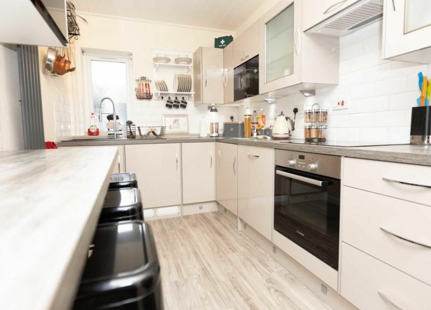 Modern kitchen at High Grade House in Acle, England, GB featuring stylish countertops and appliances.