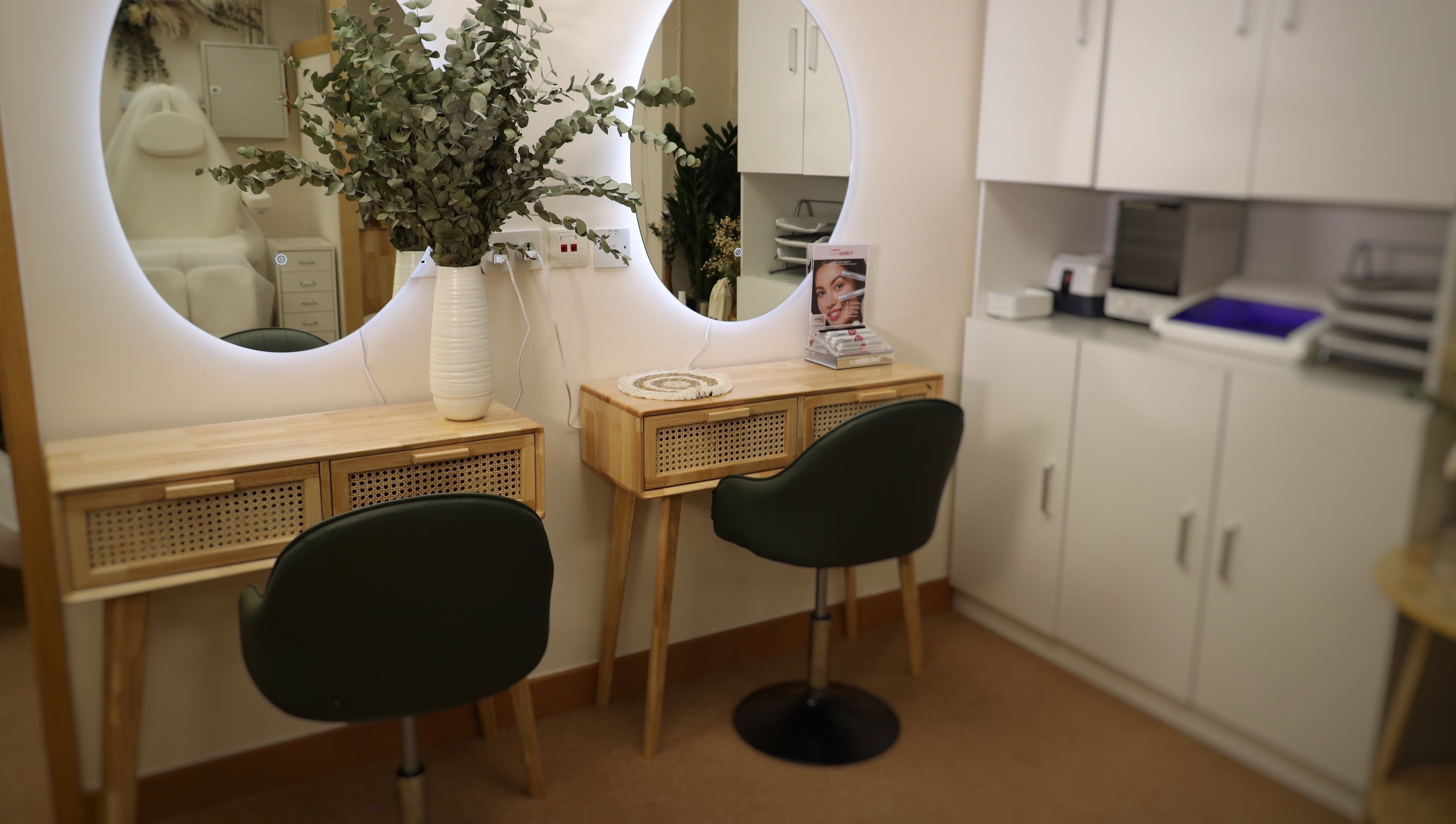 Elegant vanity setup at The Bar, Hong Kong Island, featuring a round mirror and lush greenery.