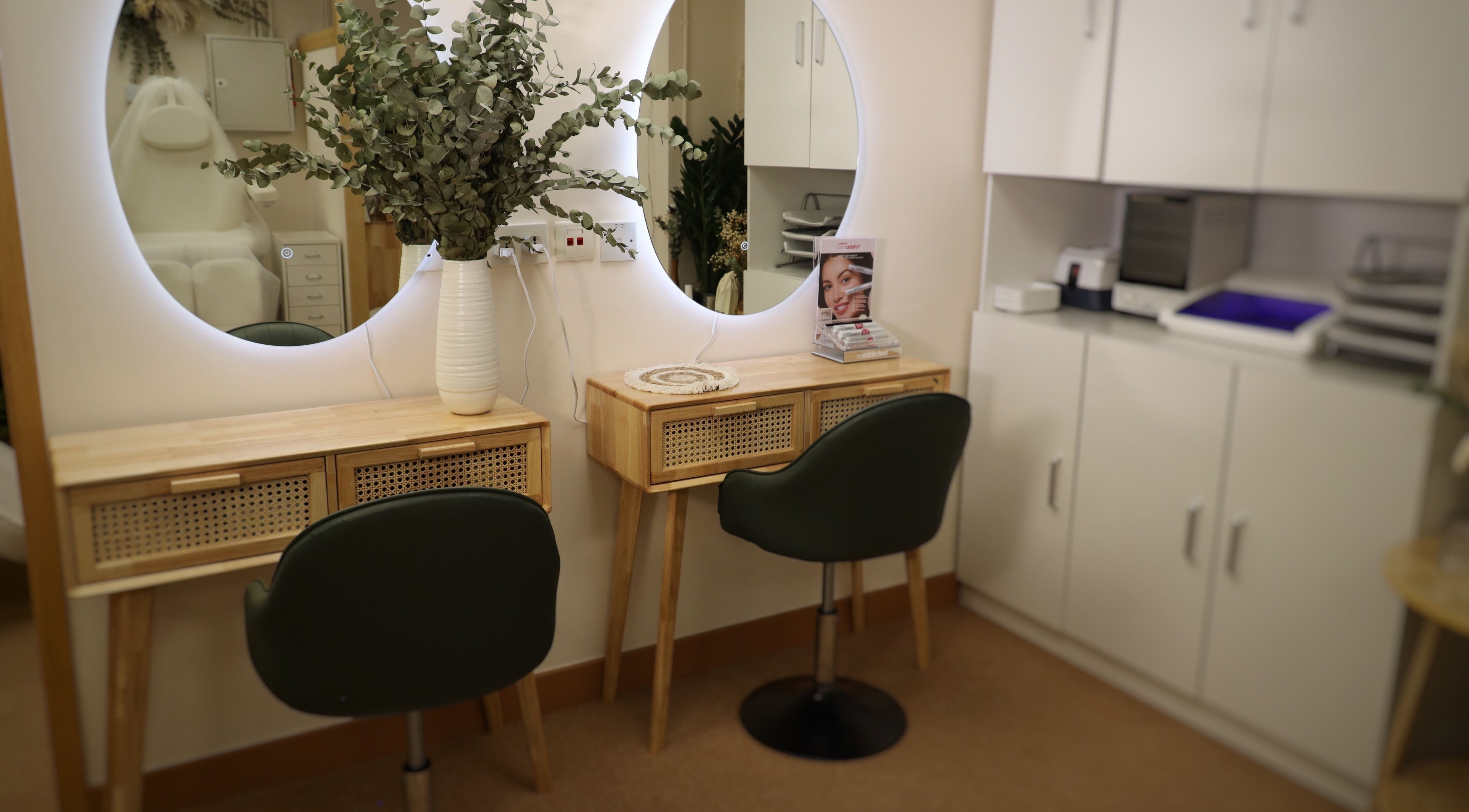 Elegant vanity setup at The Bar, Hong Kong Island, featuring a round mirror and lush greenery.