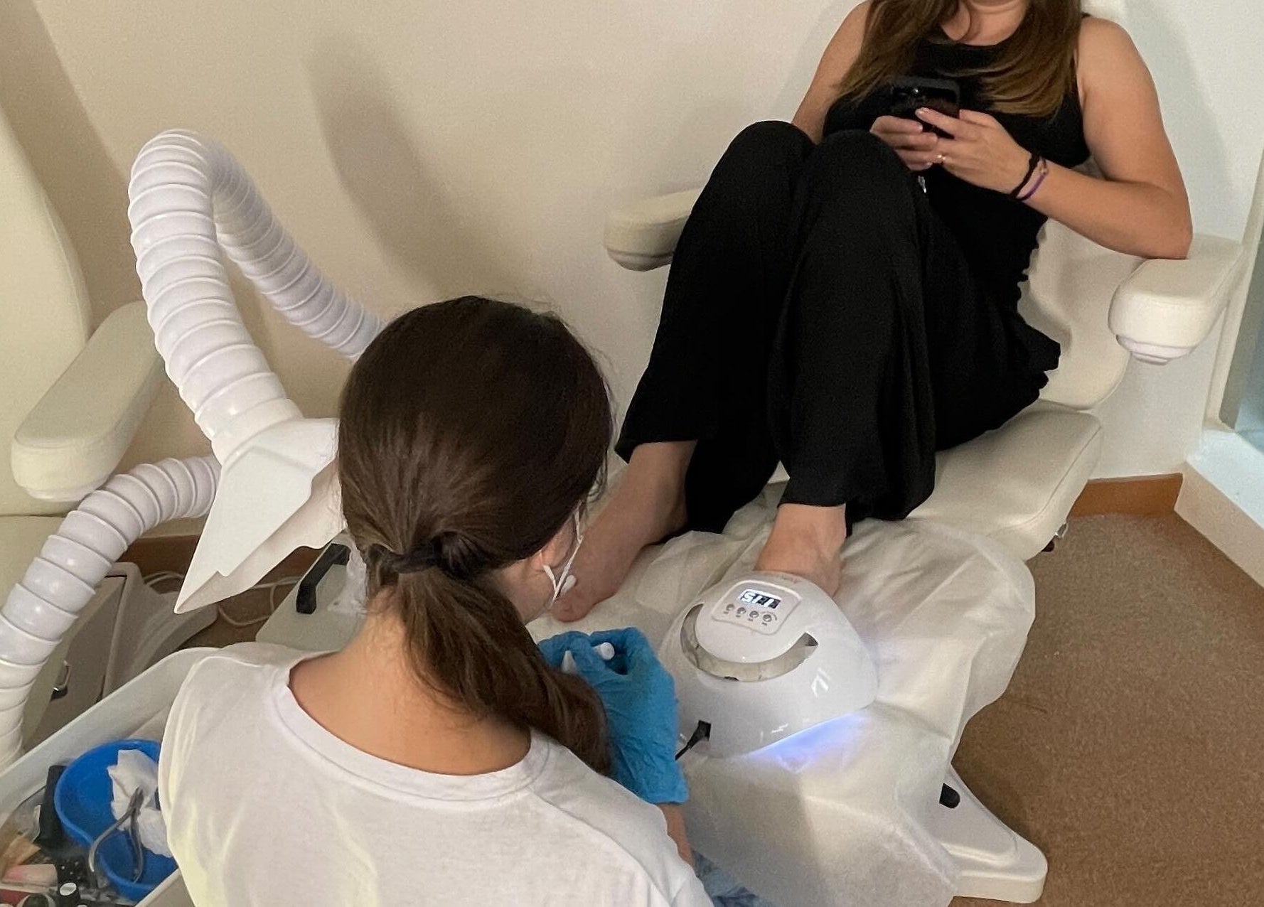 Client enjoys a pedicure at The Bar, Hong Kong Island, Hong Kong Island, HK, in a serene setting.