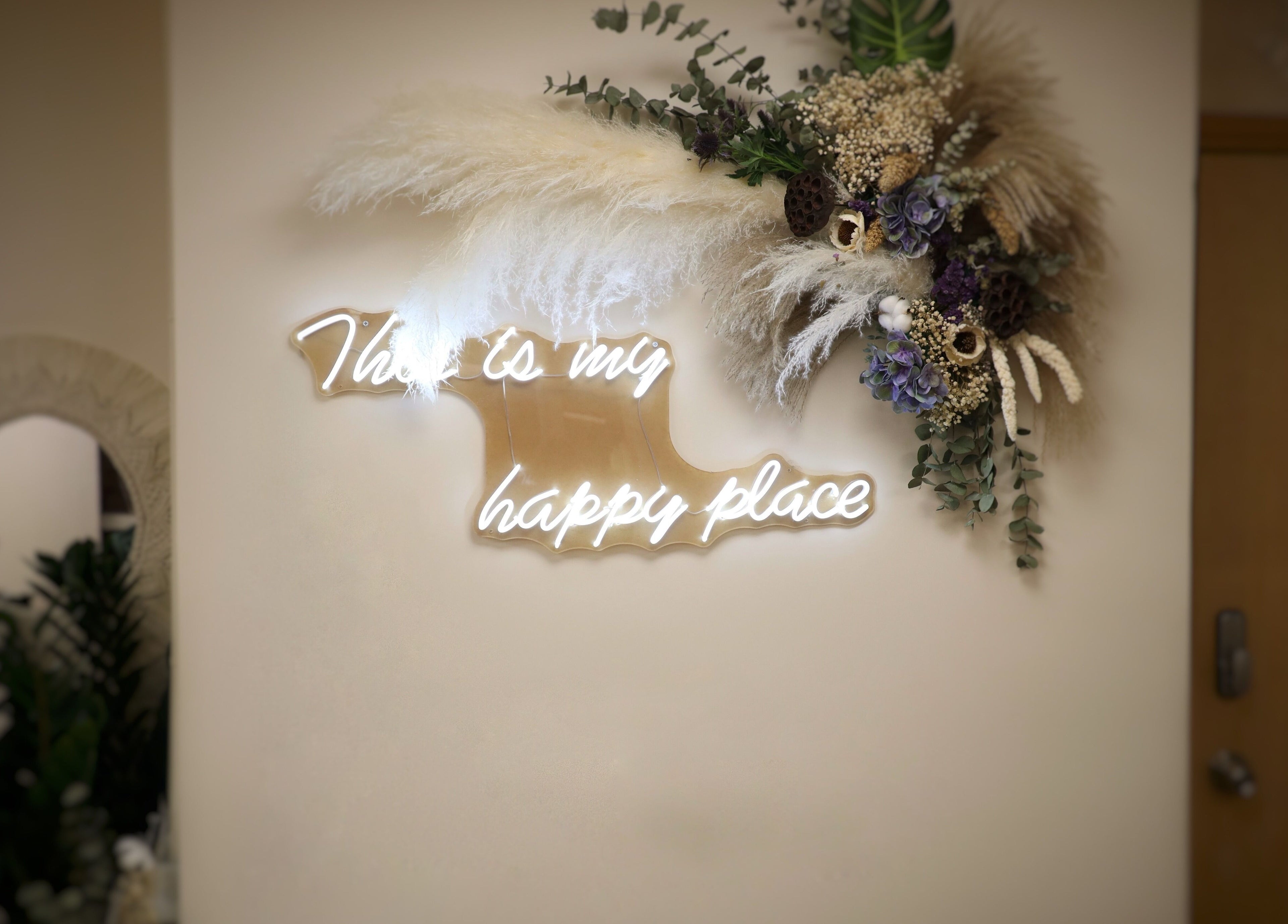 Neon sign and floral decor at The Bar, Hong Kong Island, HK, creates a cozy and inviting atmosphere.