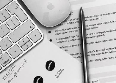 Desk setup at Bespoke Beauty & Skincare in Baildon, England, with keyboard and documents.