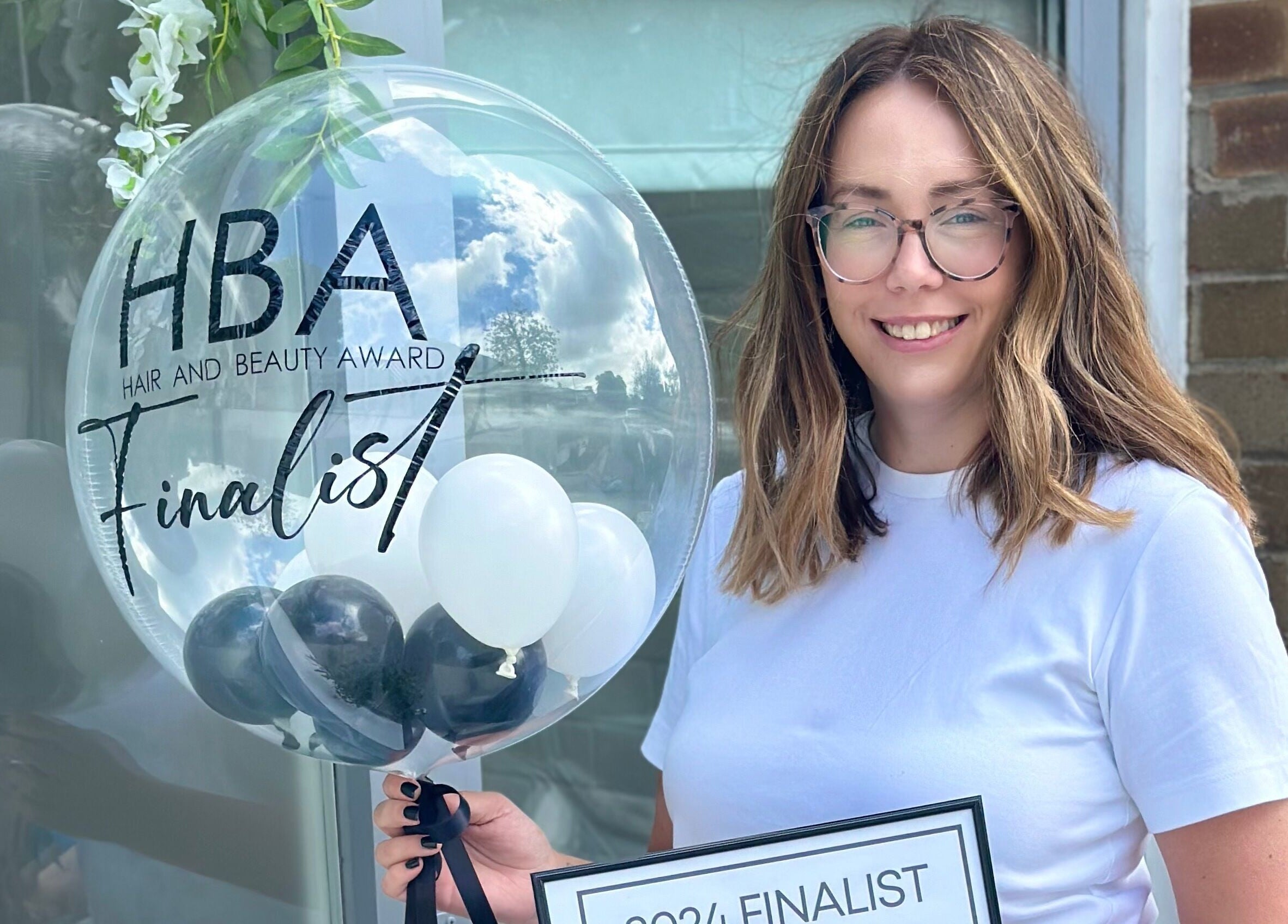 Bespoke Beauty & Skincare finalist smiling with award balloon, Baildon, England, GB.