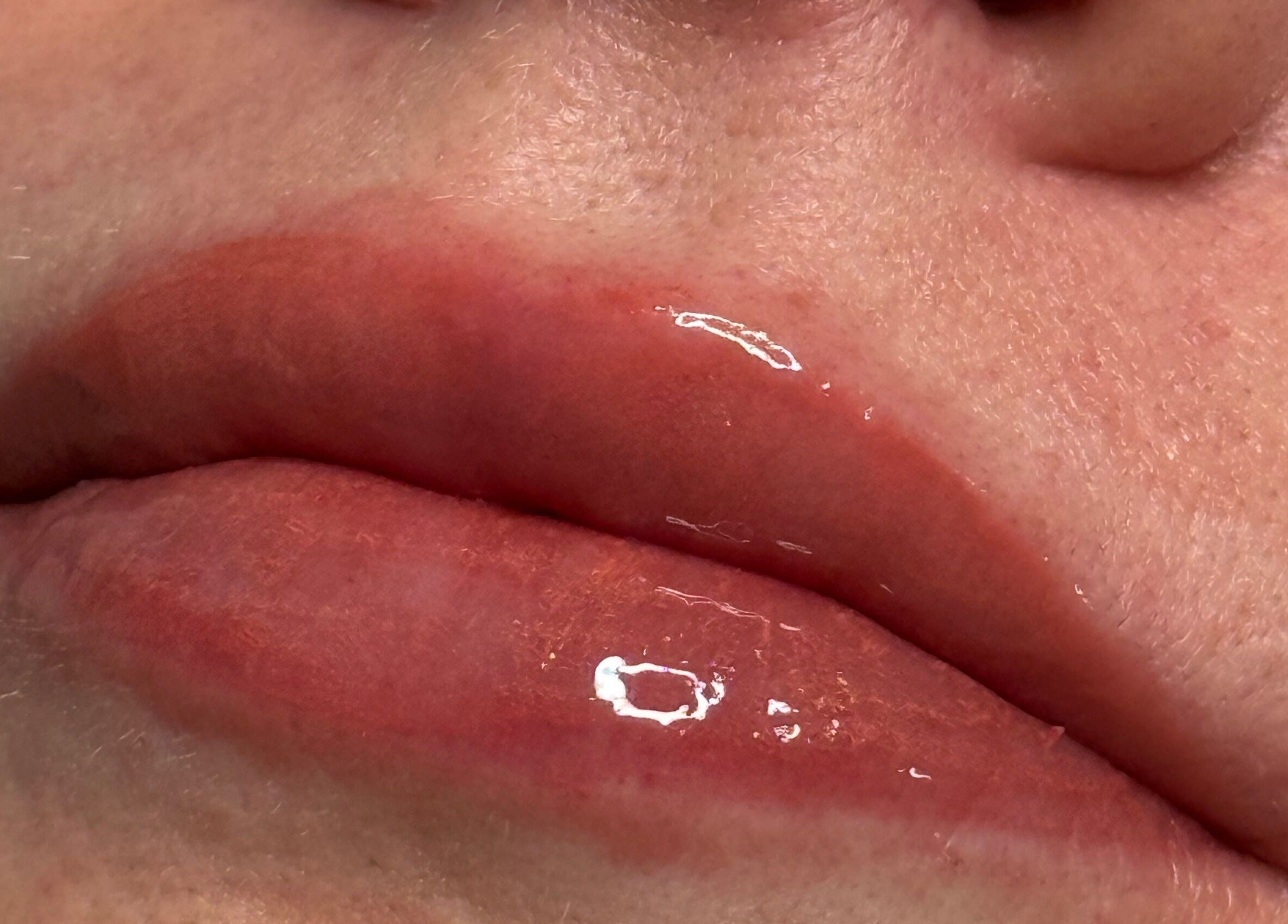Close-up of glossy, plump lips after treatment at Bespoke Beauty & Skincare, Baildon, England, GB.