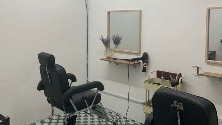 Modern styling station at Huffaz Hairstudio, Kapar, Selangor, MY, featuring sleek chairs and elegant decor.